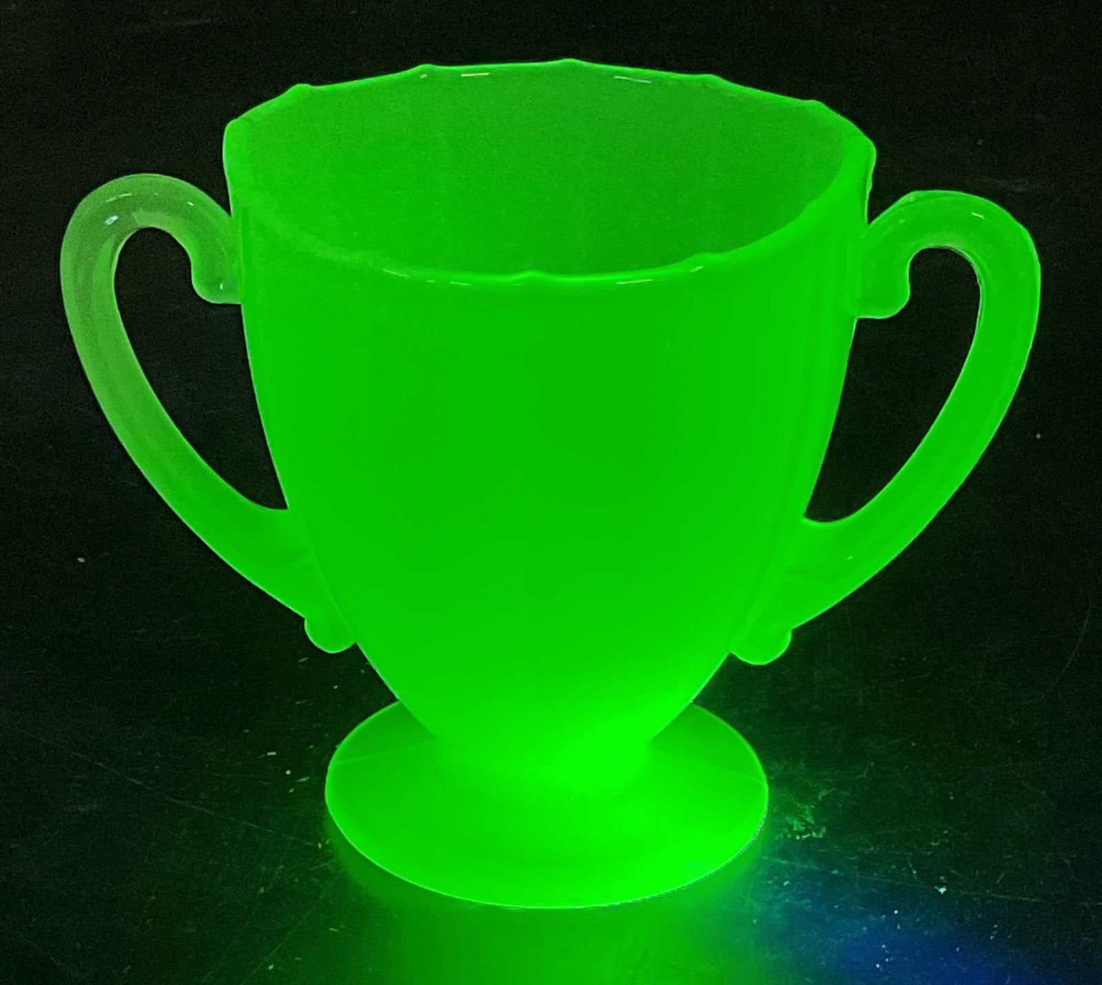 Vintage Uranium Jade Glass Sugar Bowl: Vintage uranium jade glass sugar bowl. Urn shaped with double handles and pedestal base. Measures approx 4.5 x 2.75 x 3.25 inches. Glass is UV light reactive. Some scratching. Uranium glass,