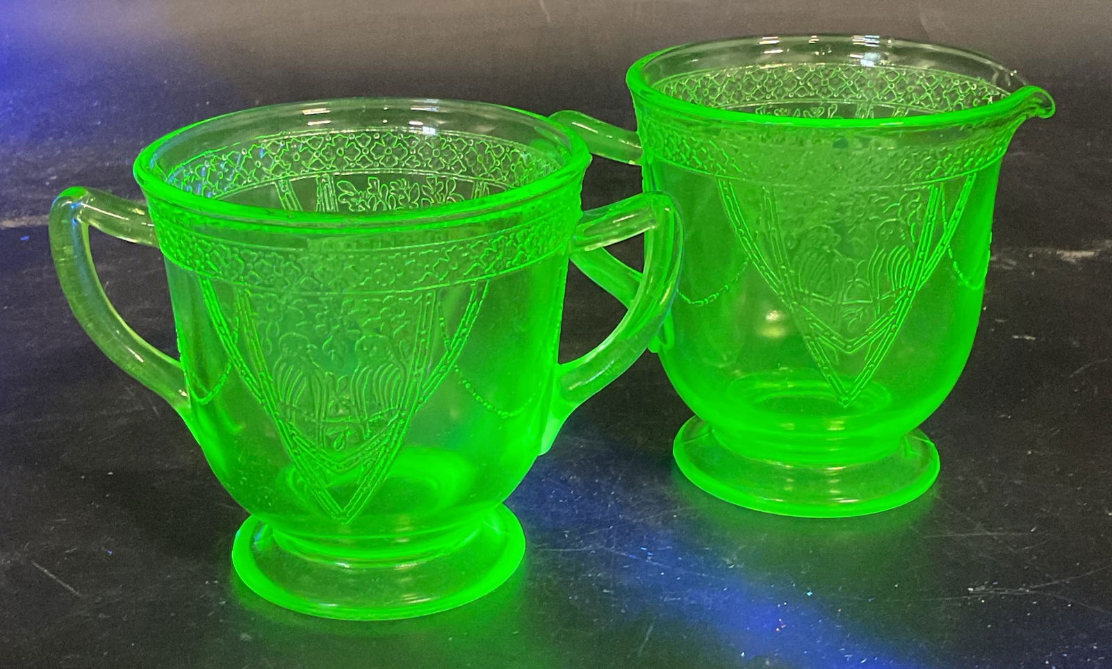 Pair Vtg Uranium Glass Sugar Bowl & Creamer: Pair of vintage matching uranium glass sugar bowl and creamer. Style of Federal Glass, not signature or markings. Lovebirds and floral bouquet design. Creamer measures approx 4.5 x 3.5 x 3.75