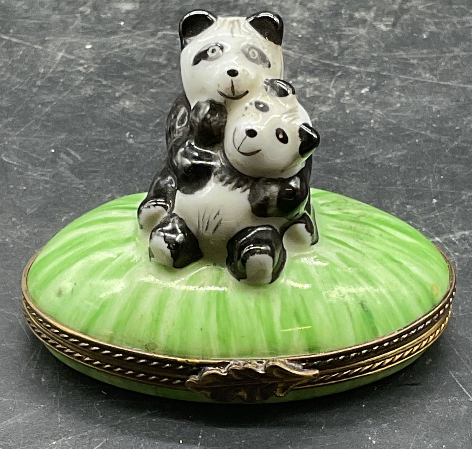 Limoges Porcelain Pandas Trinket Box France: Limoges porcelain trinket box with panda bears. Signed. Made in France. Hand painted. Measures approx 2.5 x 1.5 x 2 inches. Some wear including scratching. Limoges trinket box, porcelain trinket box,