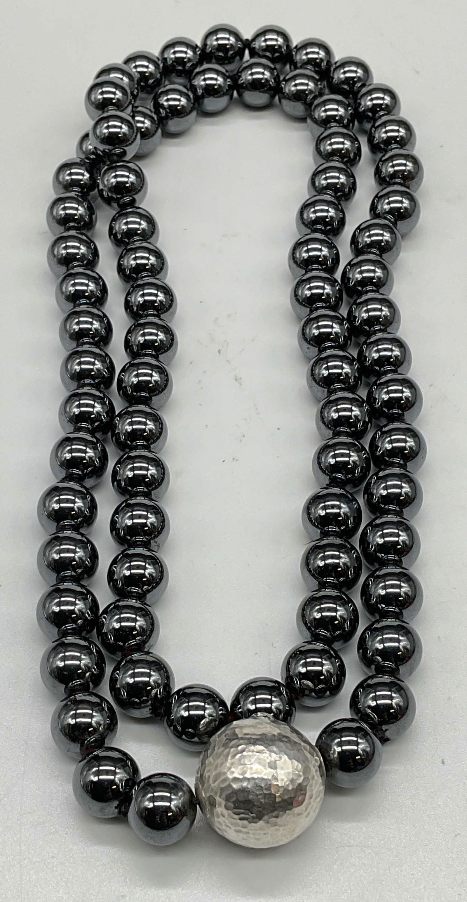 Tiffany Paloma Picasso Sterling Hematite Necklace: Vintage Tiffany & Co necklace designed by Paloma Picasso. Round hematite beads with hammered sterling silver bead. Signed on silver T & Co, made in Italy, marked sterling. Drop length approx 14 inches