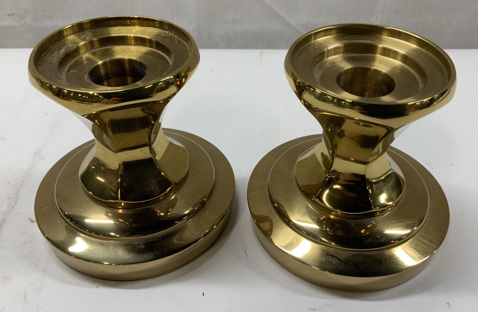 Pair Waterford Crystal Brass Candlestick Holders: Pair of brass candlestick holders part of the Waterford Crystal and Brass Collection. Round base & faceted stem. Pieces have weight. Signed & marked on underside. Reads, WATERFORD CRYSTAL. Surface wea