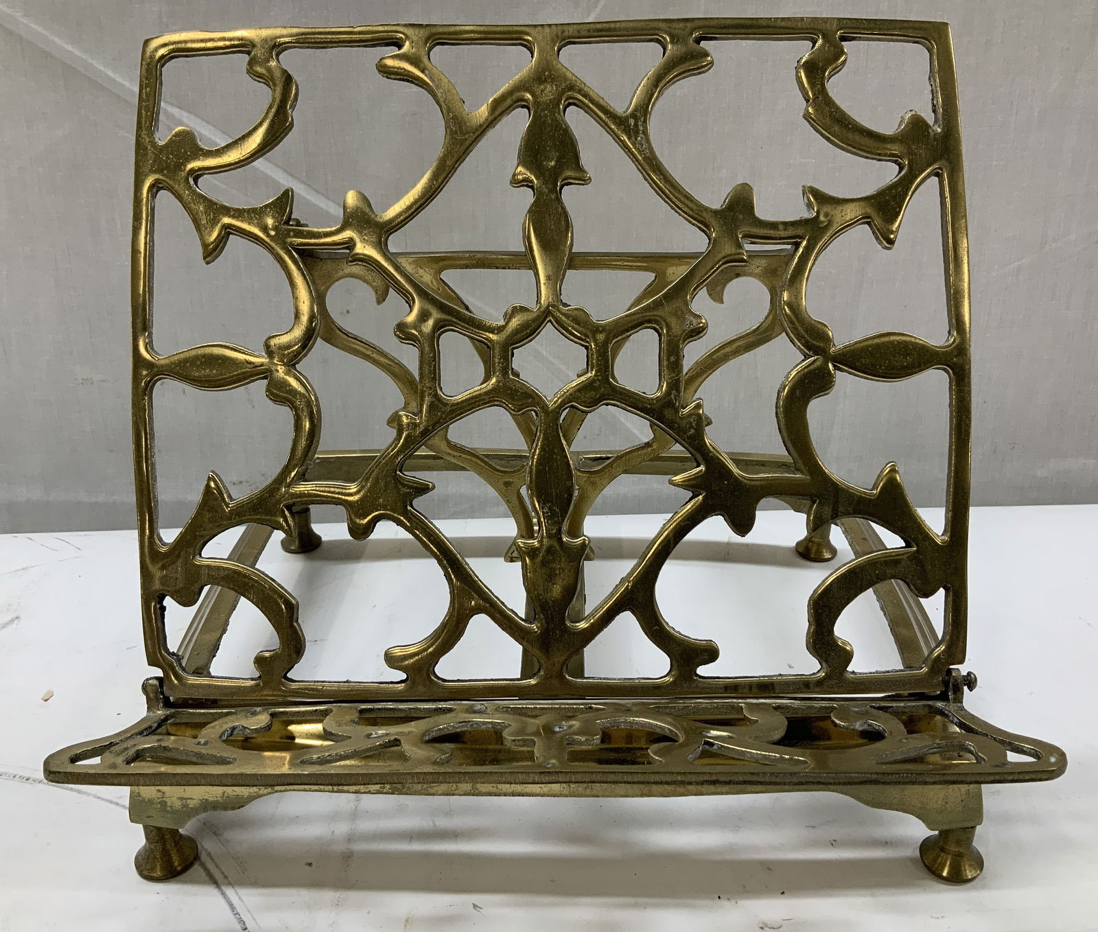 Vtg Ornate Brass Adjustable Book Stand: Vintage brass book stand features an intricate, reticulated style. Stand is adjustable, allowing for different angles to hold books. No visible signature or markings. Surface wear consistent to age, u