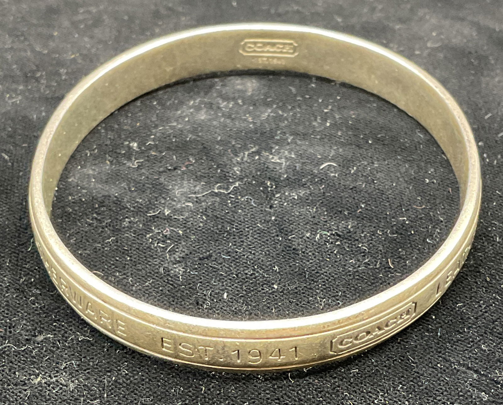 Coach Sterling Silver Classic Signature Bangle: Signed Coach Sterling silver classic signature motif bangle bracelet. Marked sterling. Measures approx 2.5 inches wide. Total weight 30.3 grams. Some scratching. Jewelry, estate jewelry, fine jewelry,
