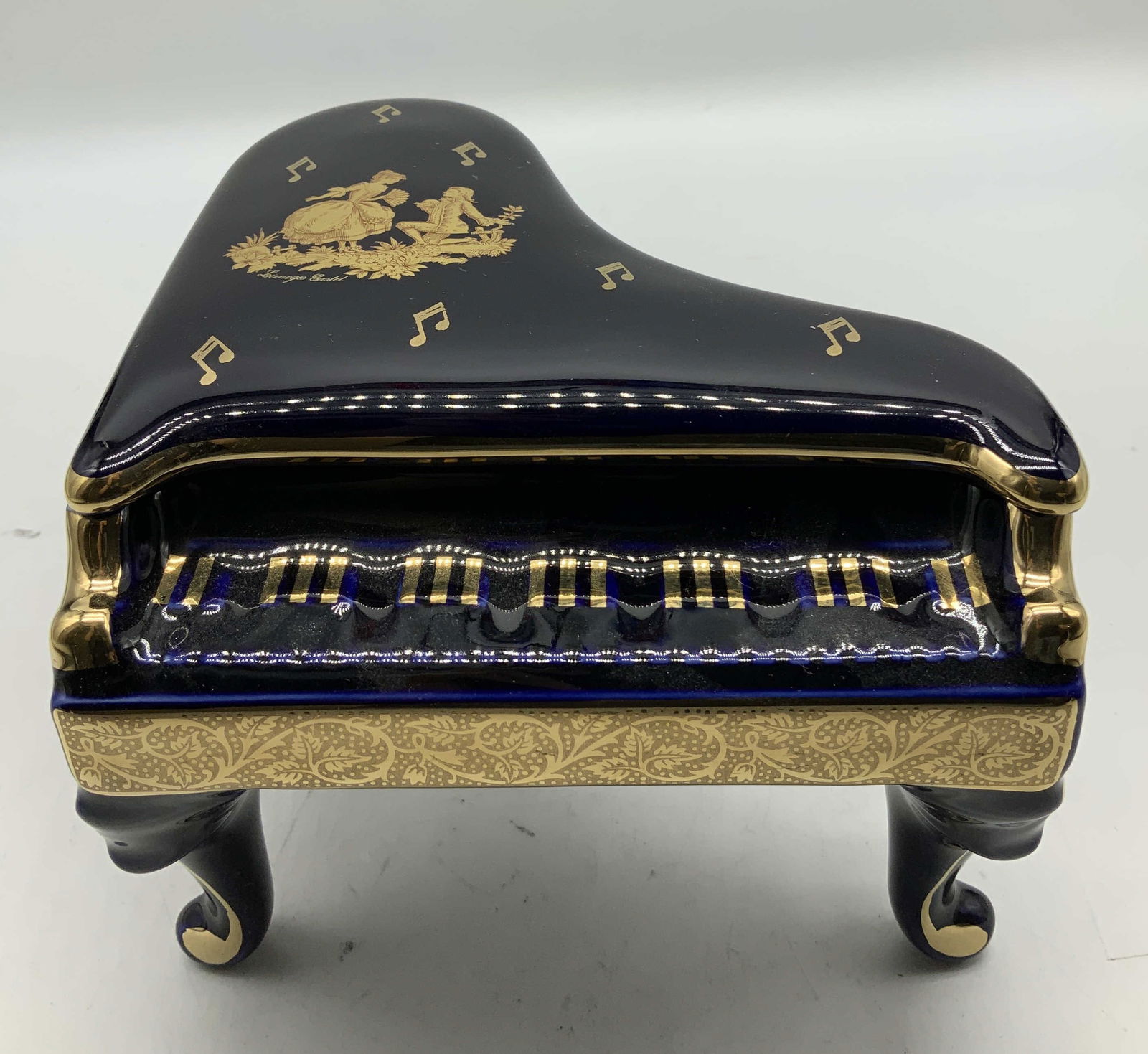 Vtg Limoges Castle Courting Couple Piano FRANCE: Vintage Limoges Castel cobalt blue & 22k gold piano with a courting couple scene. Features musical notes & floral detailing. Piece is porcelain material. Comes in brown box. Signed & marked on