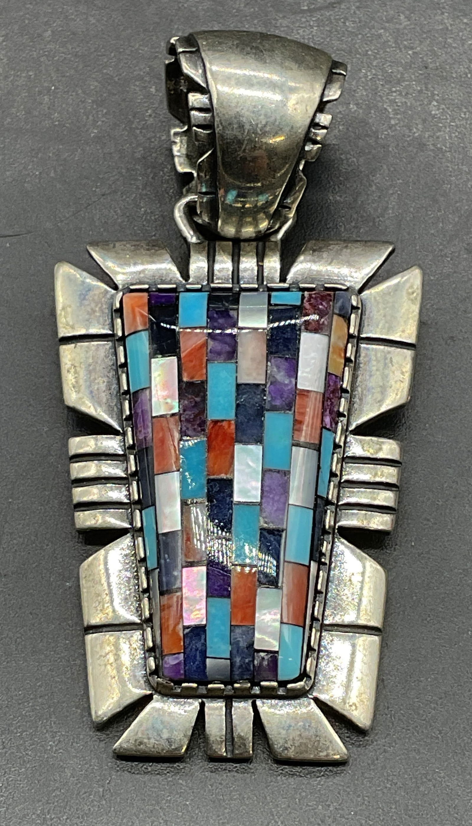 Carolyn Pollack Relios Sterling Silver Pendant: Signed Carolyn Pollack Relios sterling silver Southwest style pendant with inlaid turquoise, cork, mother of pearl and lapis. Measures approx 1.25 x 1 inches. Marked sterling. Total weight 13.7 grams.