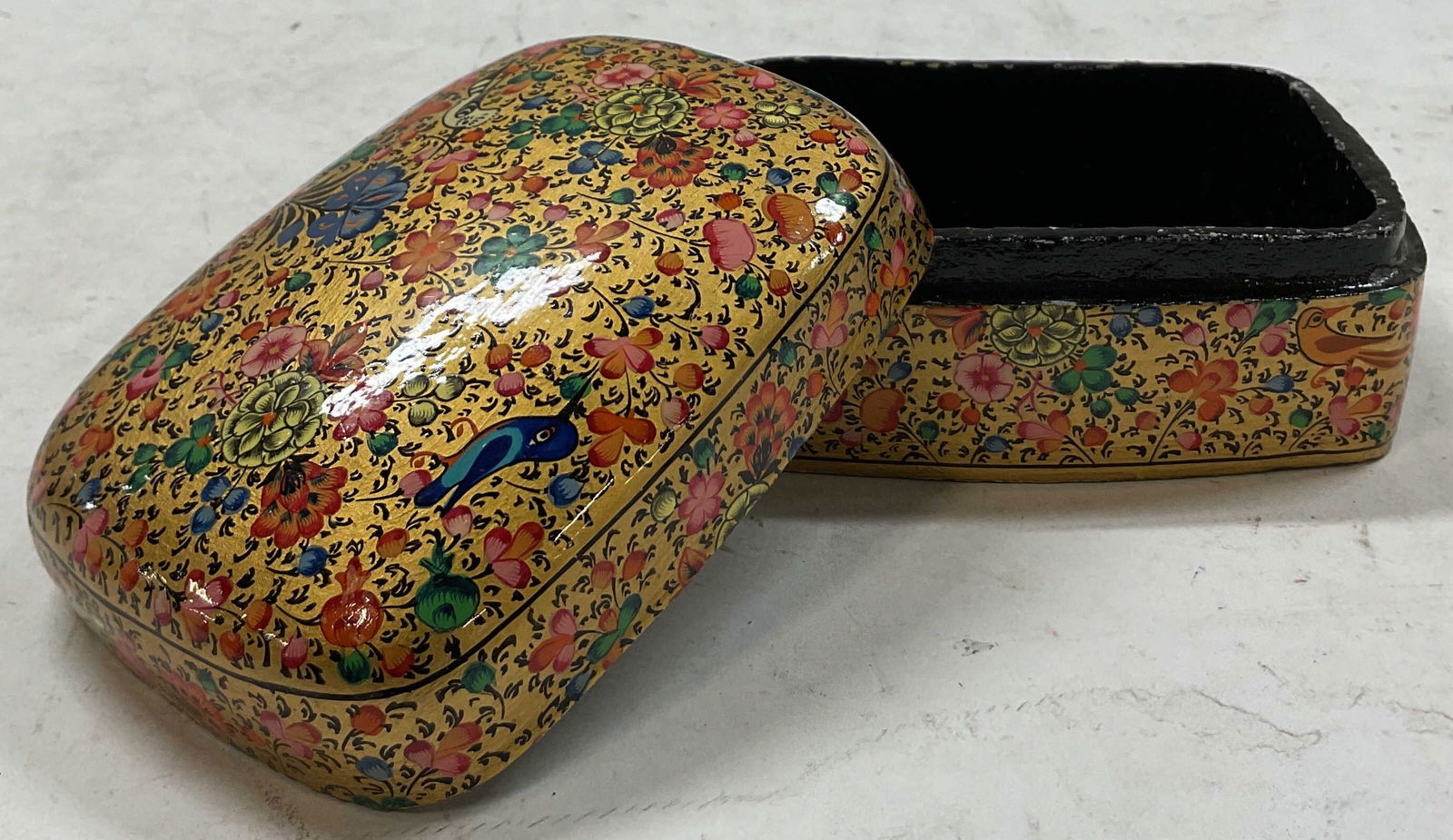 Vintage Hand Painted Lacquered Lidded Trinket Box: Vintage hand painted lacquered lidded trinket box. Square shape with dome shaped lid. Gold toned background. Hand painted floral and bird motifs. Colors include blue, green, pink, black, and more. Ins