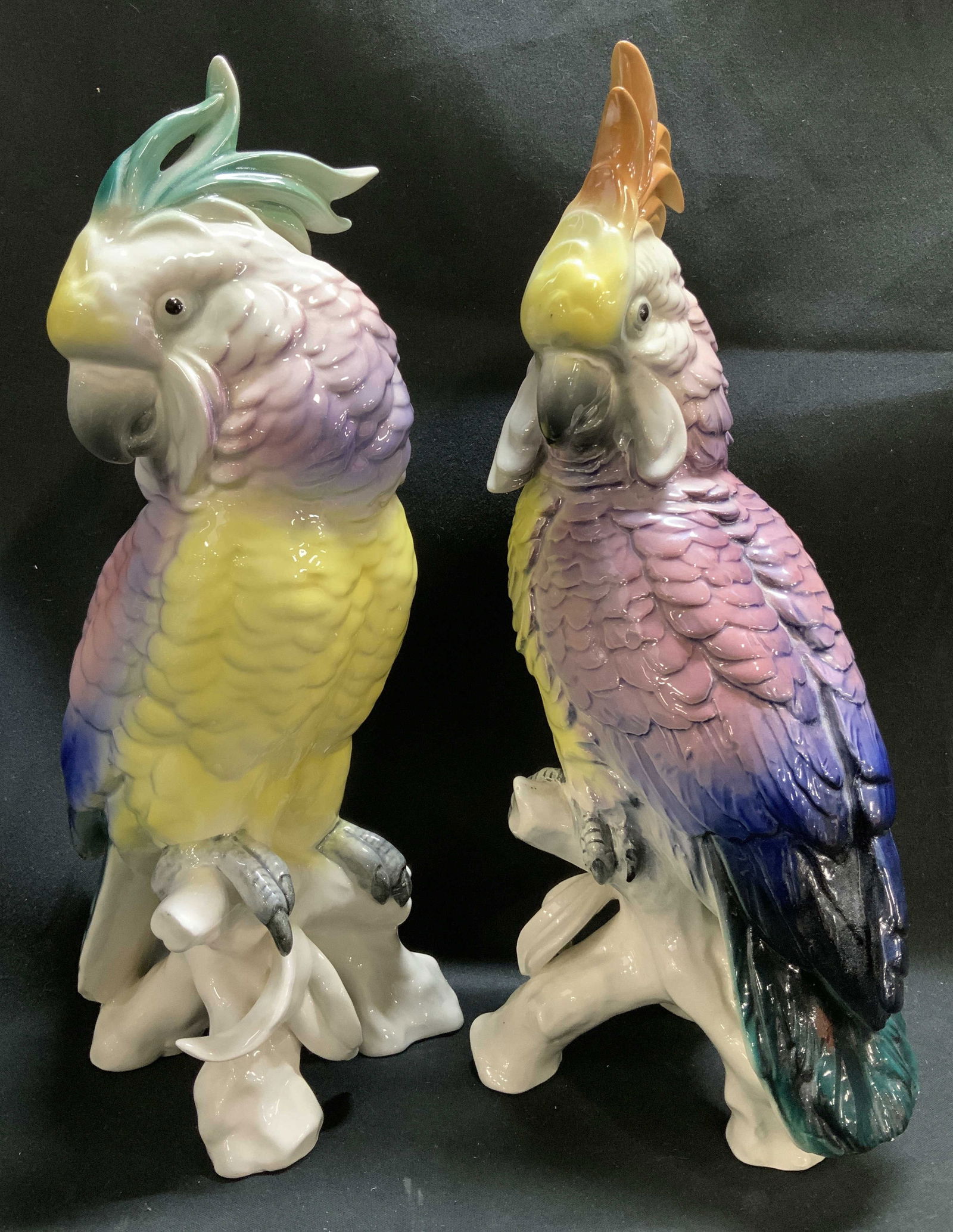 Pair Vtg Perched Cockatoo Ceramic Fig AUSTRIA: Lot includes, pair of vintage colorful cockatoo perched on a tree stump base. Shades of green, purple, yellow, orange, green & black. Glossy finish. Signed & marked on underside. Reads, MADE IN AUSTRI