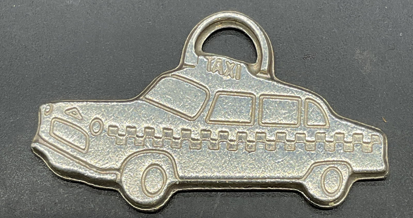 Tiffany & Co Sterling Silver Taxi Charm Pendant: Signed Tiffany & Co sterling silver taxi cab charm pendant. Measures approx 1.5 x 5/8 inches. Marked sterling. Total weight 6.6 grams. Some scratching. Jewelry, estate jewelry, fine jewelry, cocktail