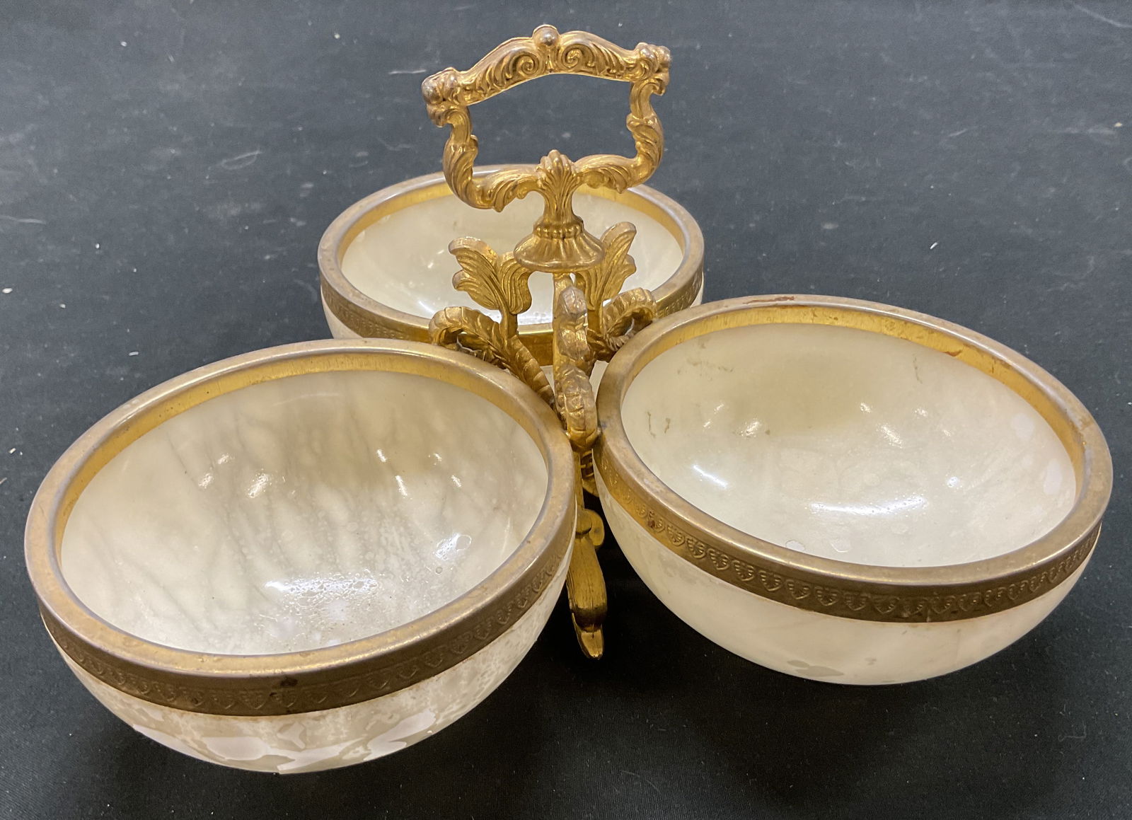 Vintage Glass & Brass Centerpiece Serving Dish: Vintage glass and brass centerpiece serving dish. Three glass bowls. Decorative brass handle and accents. Footed on underside with three decorative dolphin figures. Ornate scroll designs. Measures ht