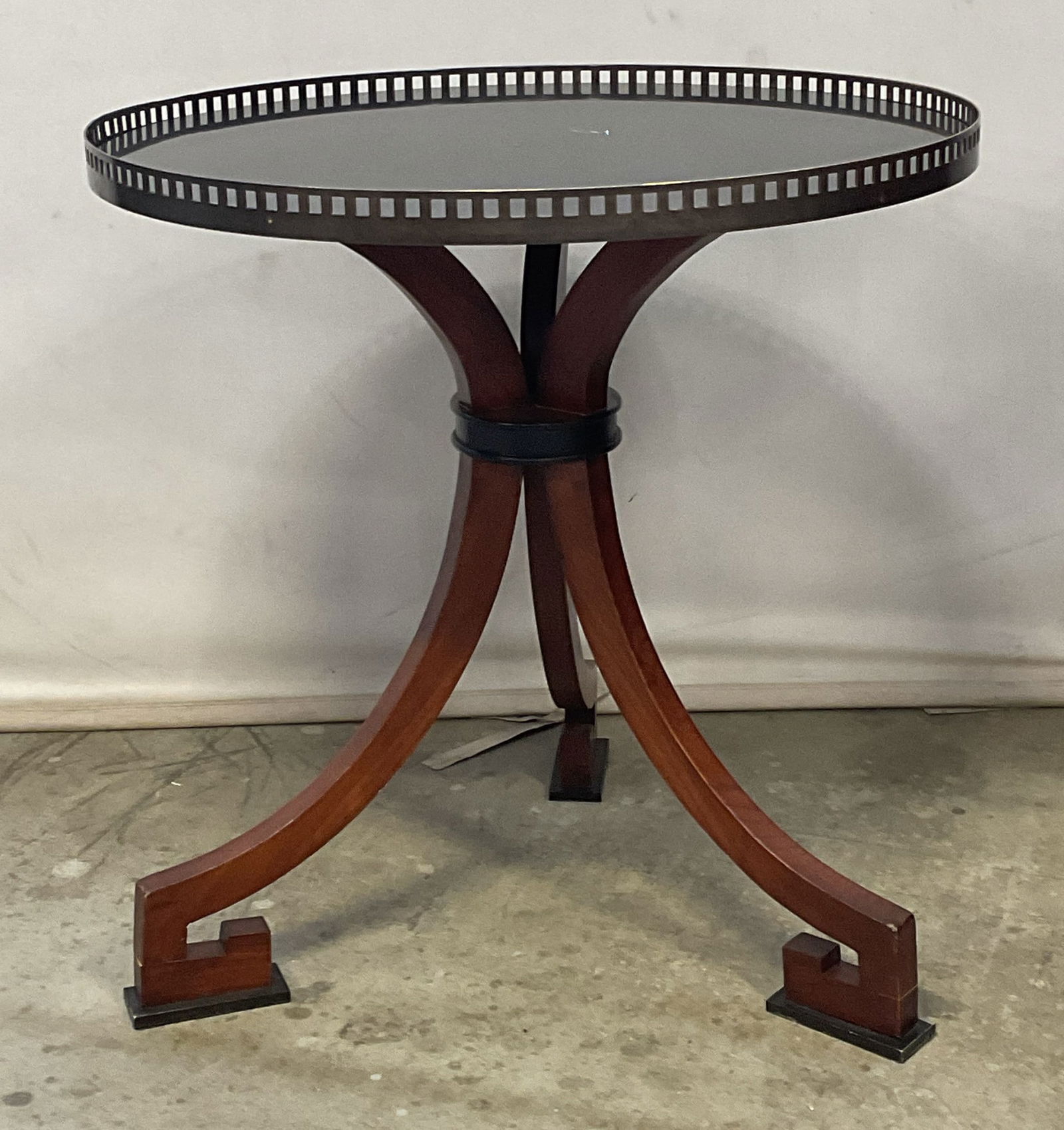 Art Deco Round Marble Top Side Table: Art deco round side table with black marble top. Tripod wood base with key feet. Raised reticulated metal rim. Measures approx 27 x 26 inches. Wear including scratching and patina. Art deco table, rou