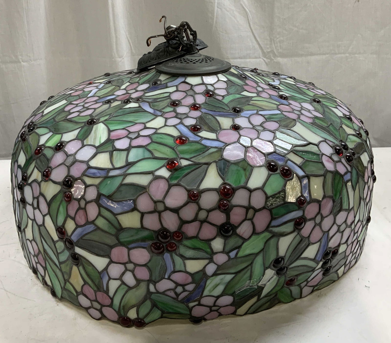 Tiffany Style Stained Glass Cherry Lampshade: Tiffany-style stained glass lampshade featuring a cherry blossom design. Lampshade has pink floral & leaf accents. Shades of blue, green, pink & white. Piece has weight. Lot is sold as is. Has