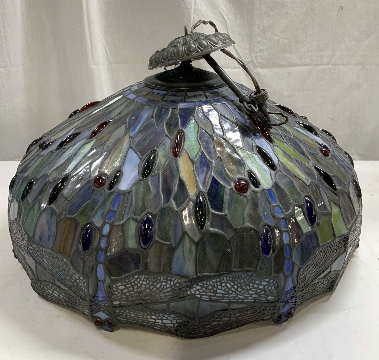 Tiffany Style Stained Glass Dragonfly Lampshade: Tiffany style stained glass lamp shade featuring a dragonfly design. Rim of lampshade features dragonfly wings & eyes. Shades of blue, green, red, orange & purple. Piece has weight. Has not been