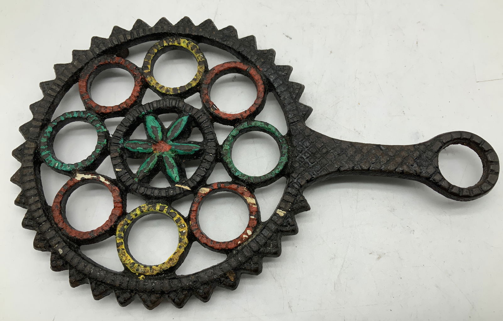 Vtg 1948 J.Z.H. Hand Painted Cast Iron Trivet: Vintage 1948 J.Z.H. cast iron trivet features a central star & 8 surrounding circles. Hand painted accents. Surface wear consistent to age, use & exposure. Signed & marked. Reads, J.Z.H. 1948. Measure