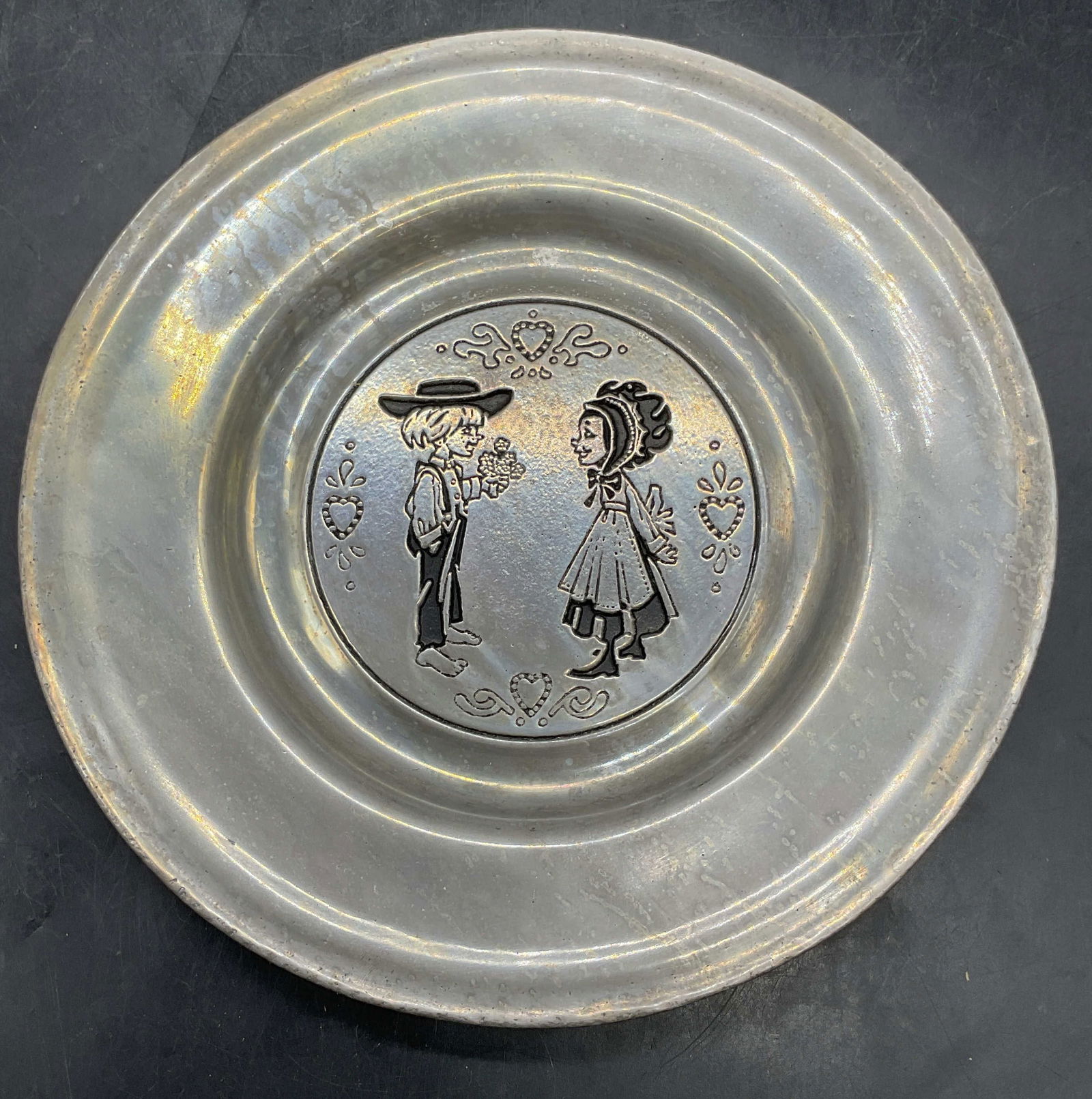Vintage PEWTAREX Aluminum Children Plate: Vintage PEWTAREX aluminum plate with children motif. Measures approx 8.25 inches wide. Some scratching. PEWTAREX plate, aluminum plate, children plate, home decor, home accessories, table decor, table