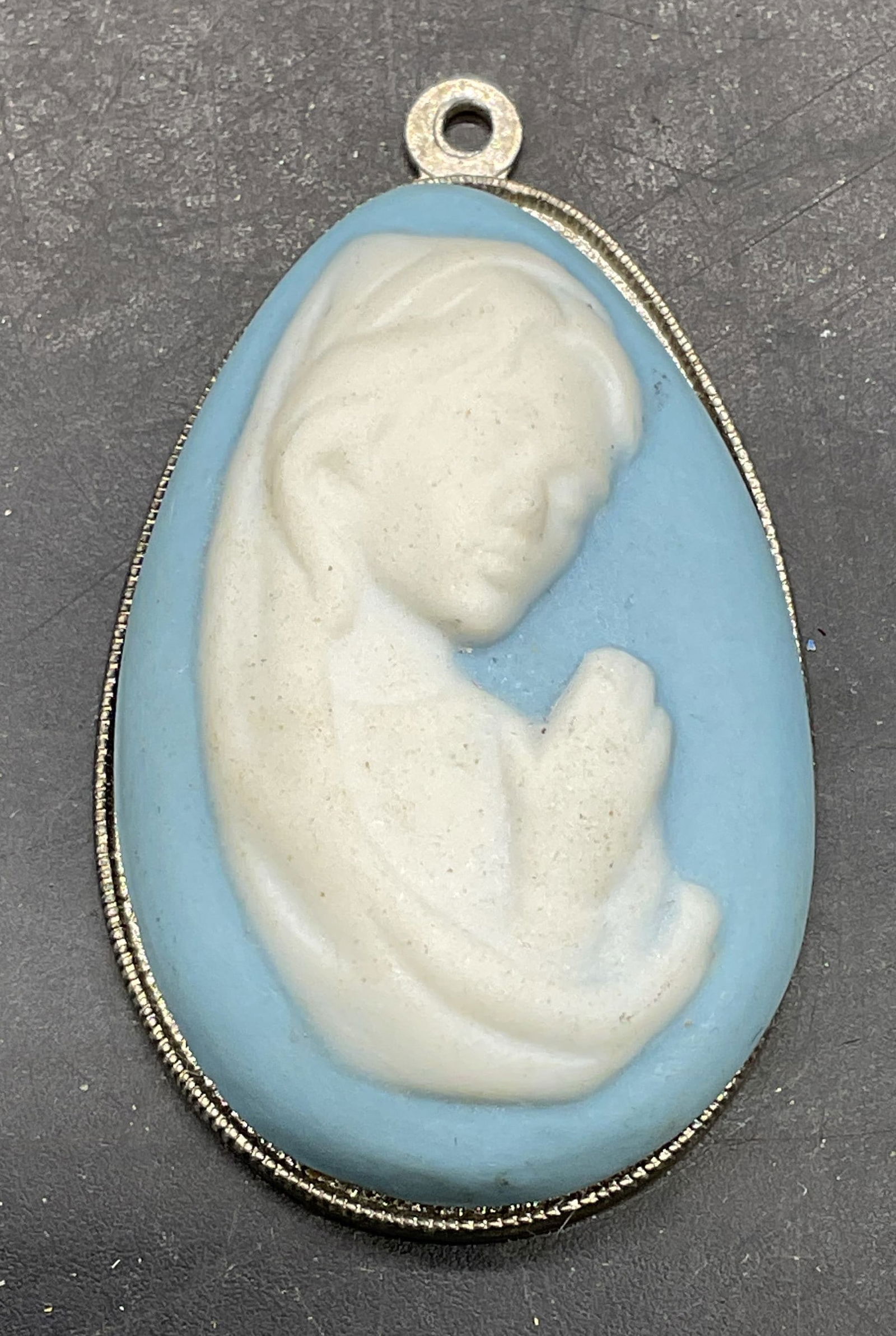 Virgin Mary Blue Ceramic Pendant: Silver tone and blue and white ceramic Virgin Mary motif pendant. Measures approx 1.75 x 1 inches. Some scratching. Jewelry, estate jewelry, costume jewelry, cocktail jewelry, fashion jewelry, accesso