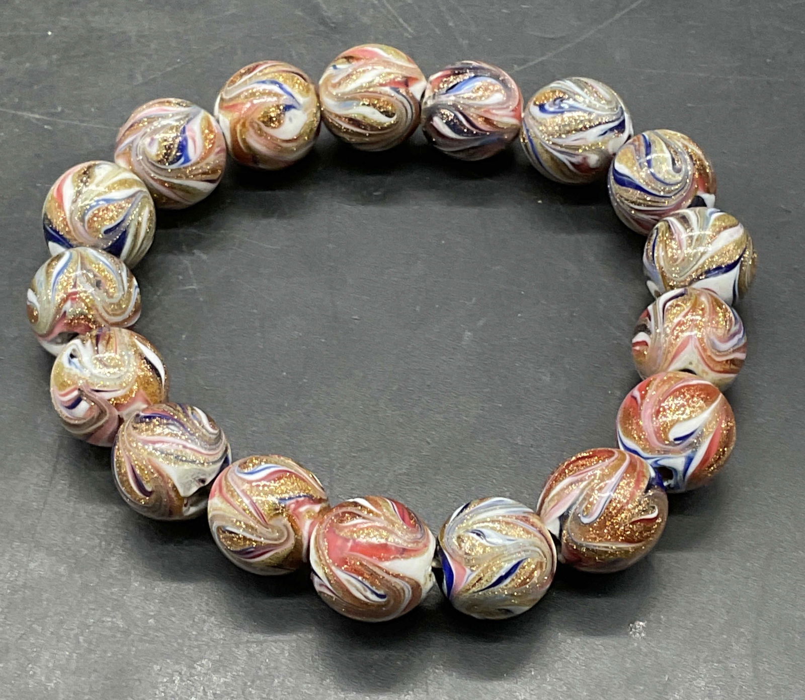 Gold Fleck Pink Blue Art Glass Bracelet: Art glass beaded stretch bracelet with pink, blue, white, and gold fleck beads. Measures approx 2.25 inches wide. Some scratching. Jewelry, estate jewelry, costume jewelry, cocktail jewelry, fashion j