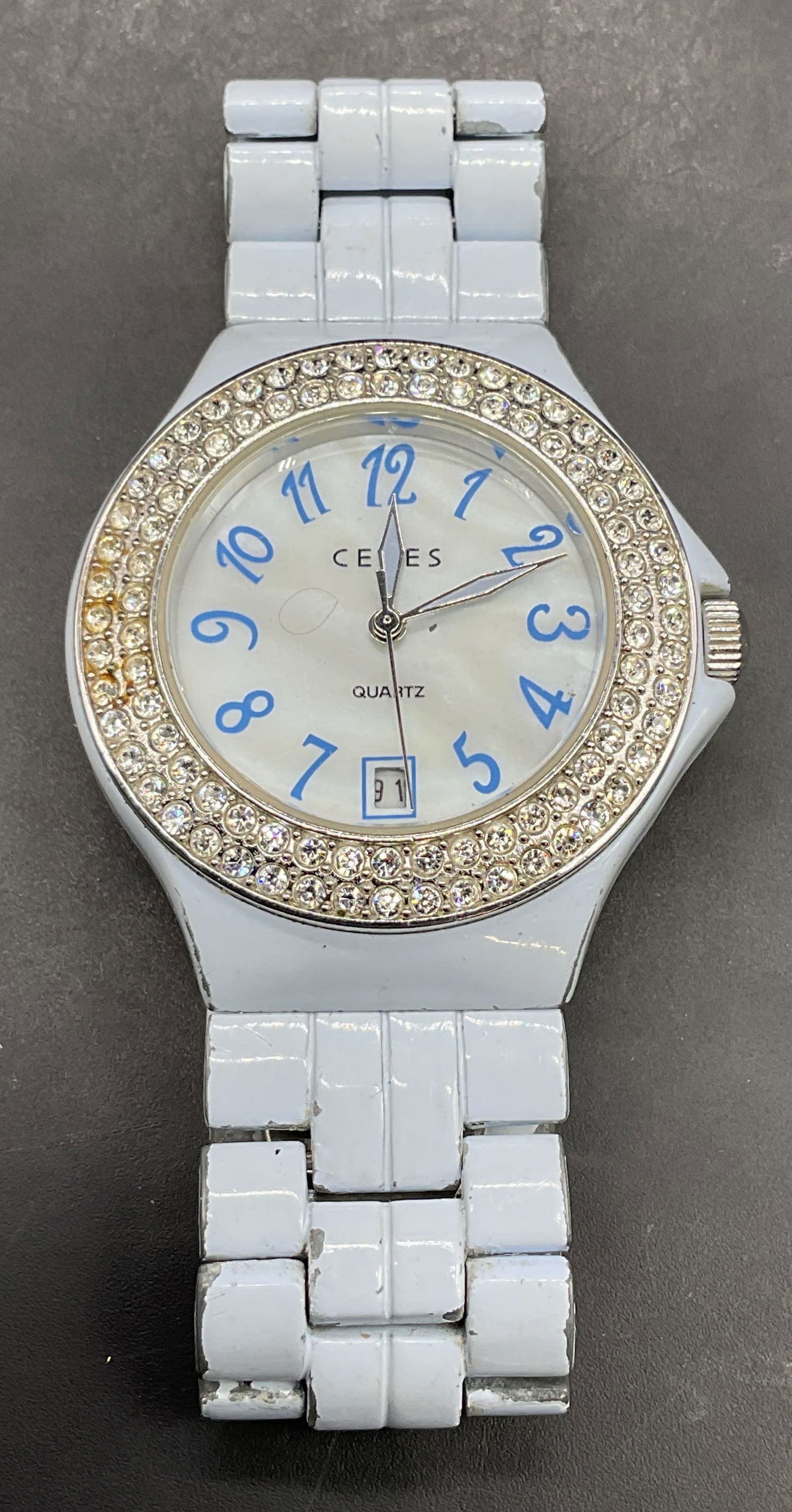 Ceres Blue Crystal Wristwatch: Signed Ceres blue wristwatch with crystal bezel. Deployment clasp. Dial measures approx 1.5 inches wide. Not tested. Some scratching. Jewelry, estate jewelry, costume jewelry, cocktail jewelry, fashio