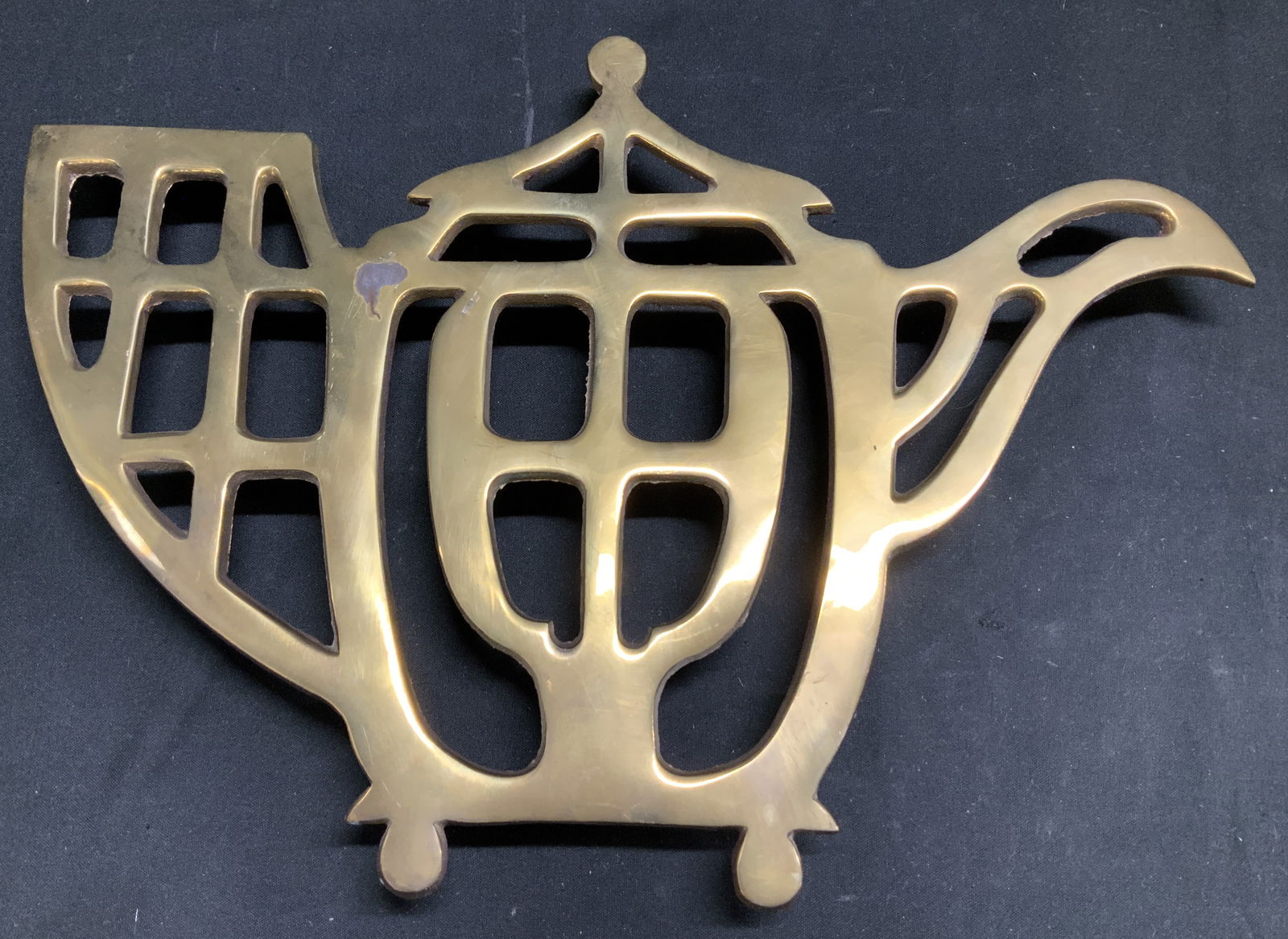 Vntg Pagoda Style Brass Teapot Trivet INDIA: Vintage pagoda style brass teapot trivet features a decorative, openwork teapot shape. 4 small feet on bottom. Signed & marked on underside. Reads, MADE IN INDIA. Surface wear consistent to age, use &