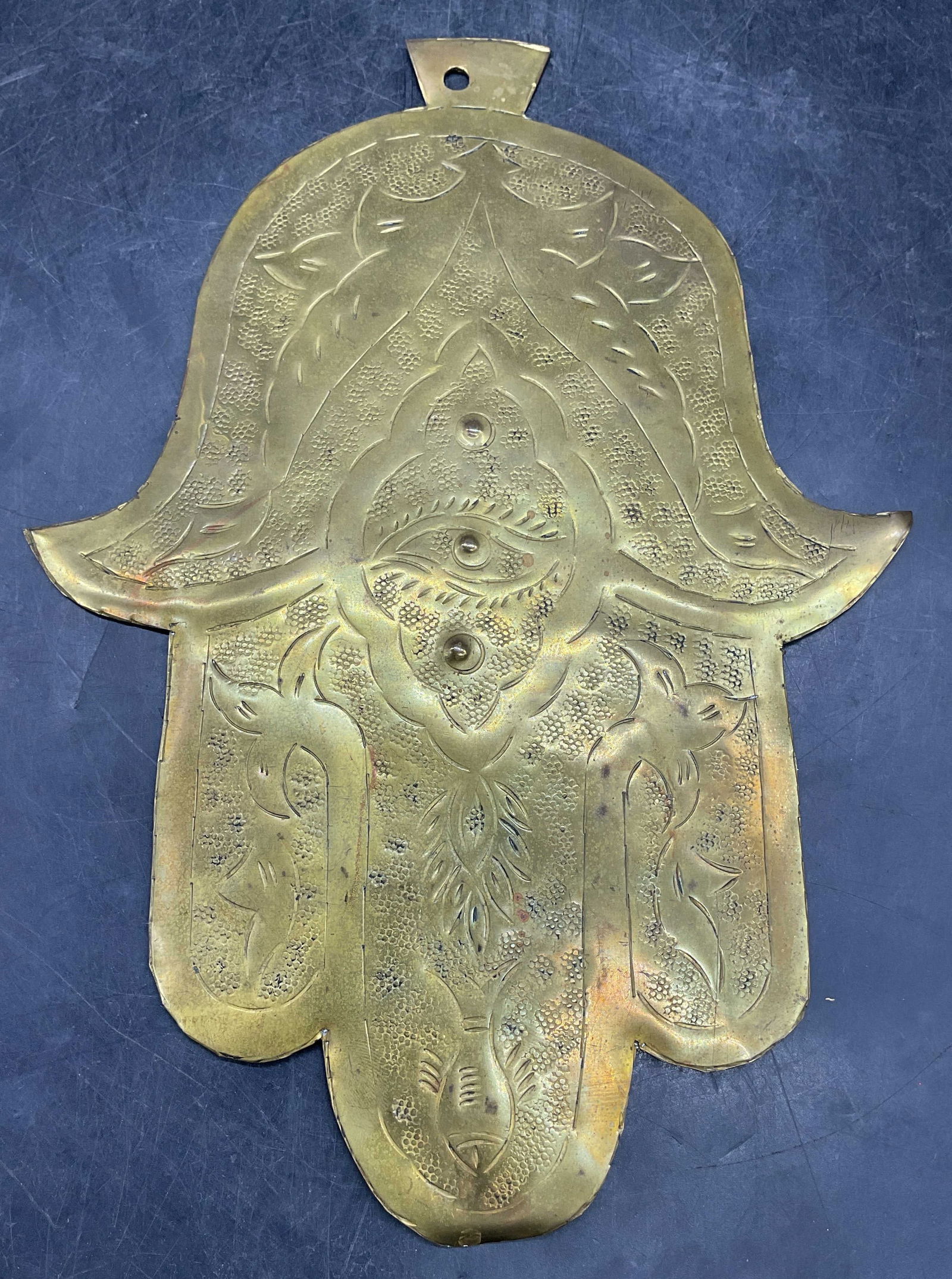 Vintage Brass Hamsa Hand Wall Plaque: Vintage etched and hammered brass hamsa hand motif wall plaque hanging. Measures approx 11 x 7.75 inches. Some warping and patina. Property of opera singers estate from the renowned and opulent Manhat