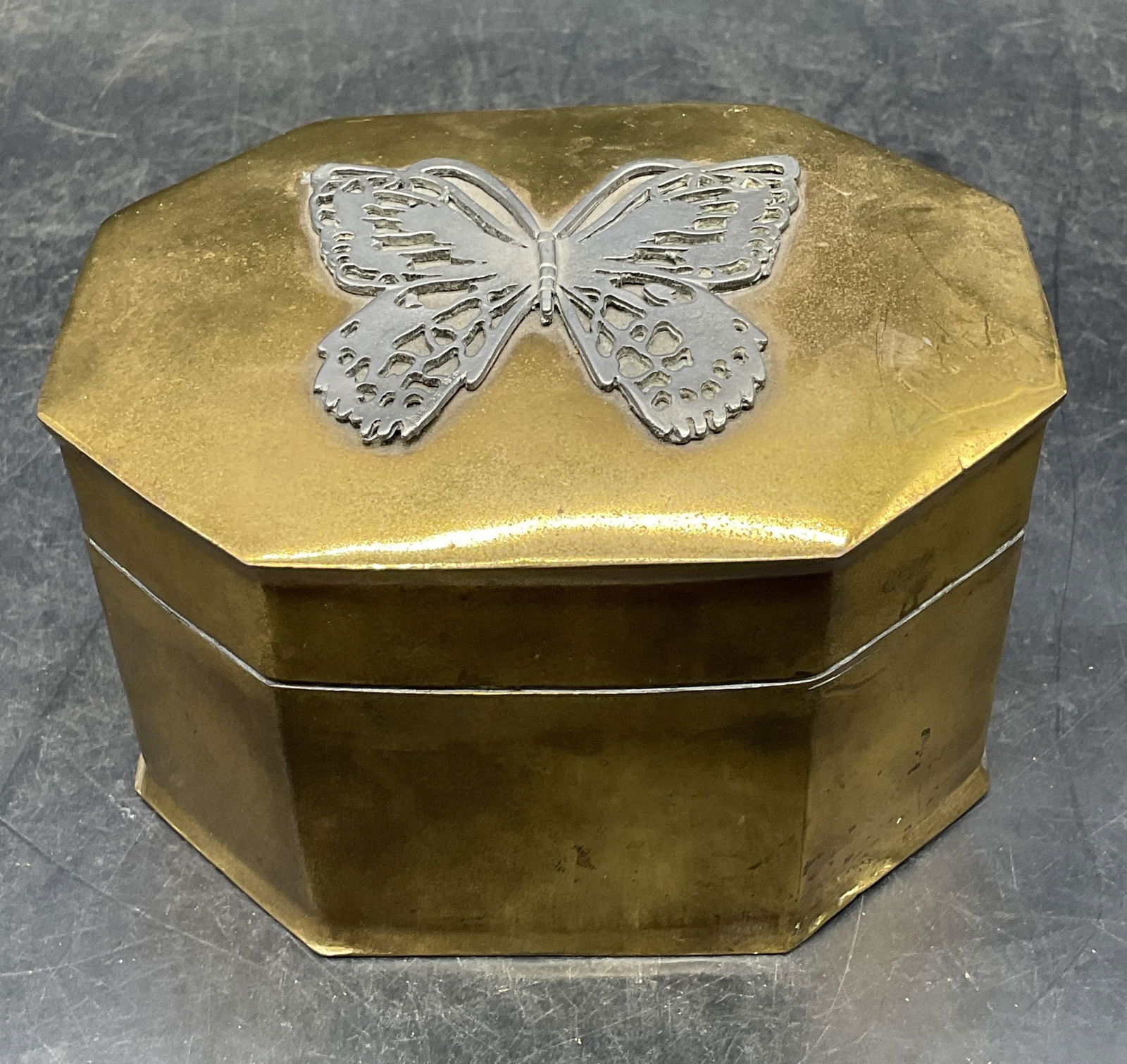 1976 Metzke Brass Silver Tone Butterfly Box: Vintage 1976 Metzke brass box with silver tone butterfly motif. Measures approx 5.25 x 4 x 3 inches. Wear including warping and scratching. Property of opera singers estate from the renowned and opule