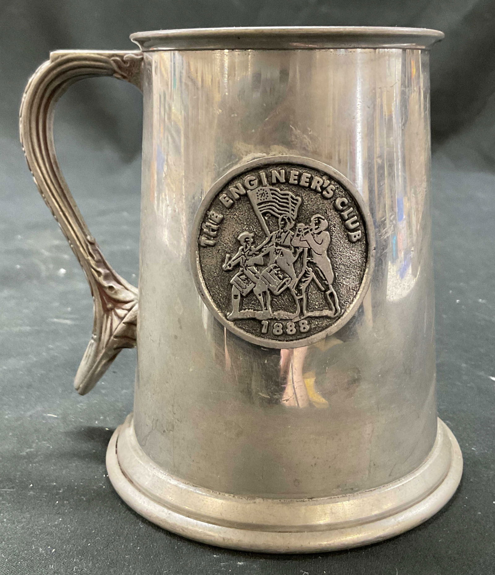Raimond Viners Of Sheffield Emb Pewter Mug England: Raimond Viners Of Sheffield embossed pewter mug. Made in England. Underside is signed and marked, reads as follows Raimond Viners Of Sheffield English Pewter Made In England. Embossed design of figure
