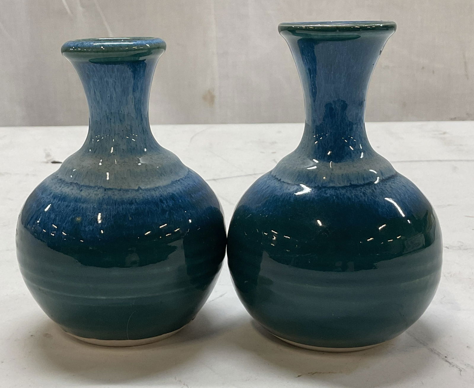Lot 2 Vintage Blue & Green Ceramic Bud Vases: Lot of 2 vintage blue and green ceramic bud vases. Marked on underside, reads illegibly. Bulbous body with narrow flared neck. Hand painted a mix of blue into green. Glossy finish. Largest measures ht