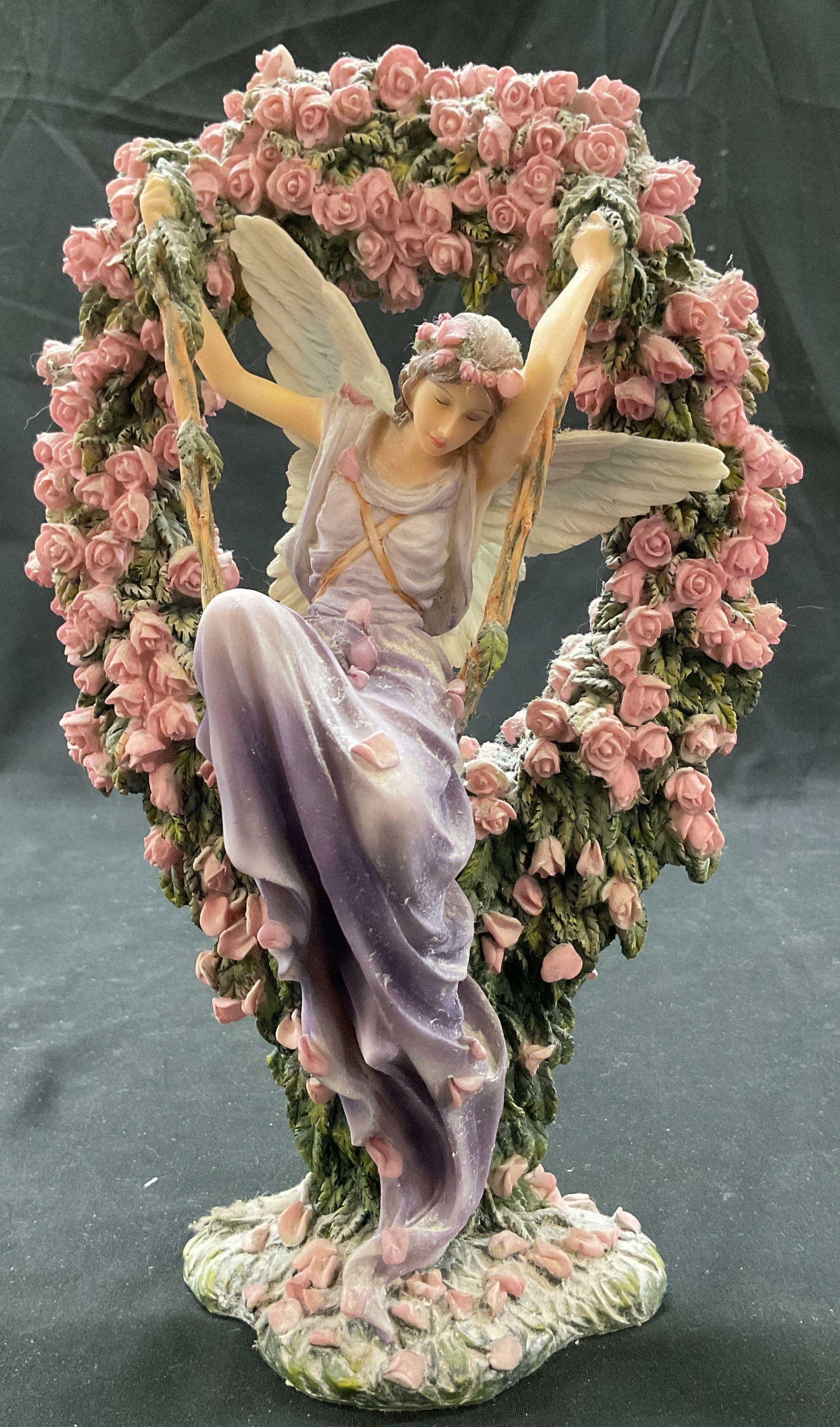 Sheila Wolk The Gatekeeper Angel Figurine: Sheila Wolk The Gatekeeper angel figurine. Not marked. Made of resign and hand painted. Angel figure with wings sitting on a swing made of vines. Heart shaped wreath surrounds her adorned with floral