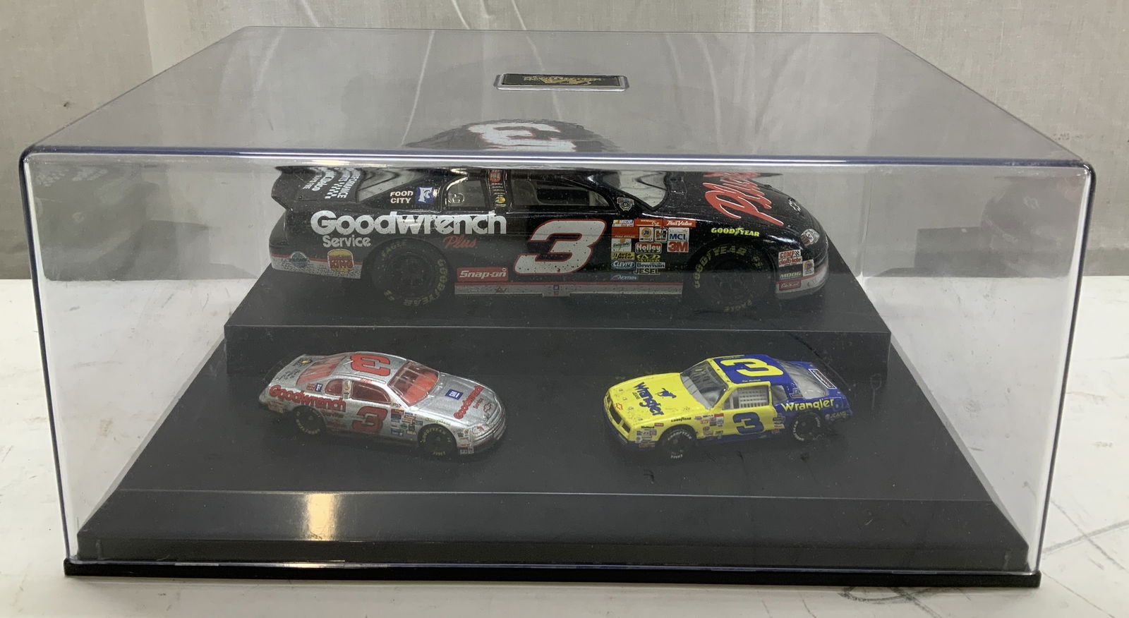 Motorsports Authentics #3 Earnhardt Die-Cast Set: Motorsports Authentics Dale Earnhardt #3 Goodwrench Winners Circle die-cast car set. Comes with 2 smaller 1:64 die cast cars. Comes with an acrylic case. Sponsor logos on car reads, Wrangler, Goodwren