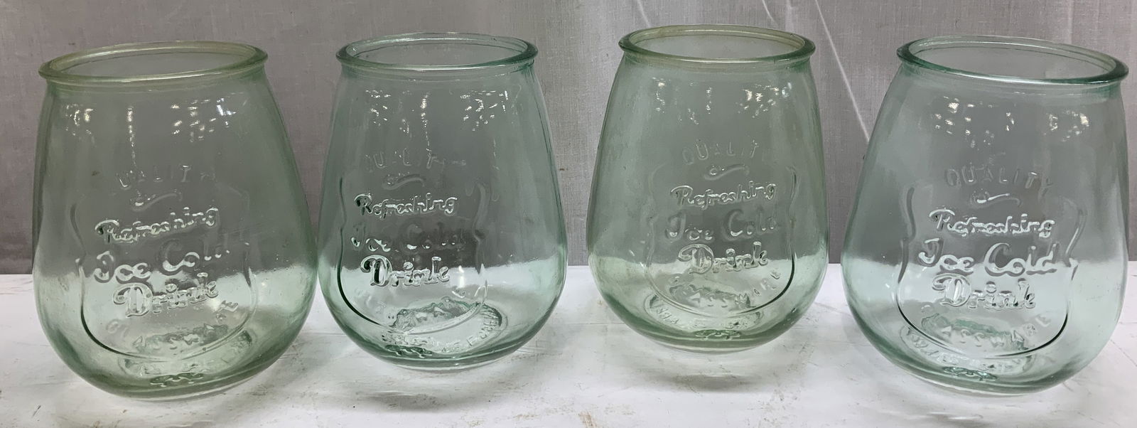 Lot 4 Home Essentials & Beyond Embossed Glasses: Lot 4 vintage Home Essentials & Beyond green drinking glasses. It features embossed text that reads Quality Refreshing Ice Cold Drink Glassware Est. 1841. Signed & marked on underside. Reads, HOME ESS