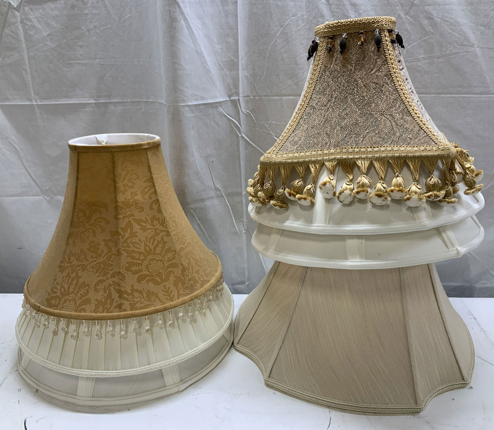 Lot 7 Vtg Assorted Fabric Lamp Shades WATERFORD: Lot includes, 7 vintage assorted lamp shades. 1 shade features a jacquard style pattern & pom-pom fringes, 1 shade features glass tassels & rest of lamp shades feature a cream or white toned. Fabric m