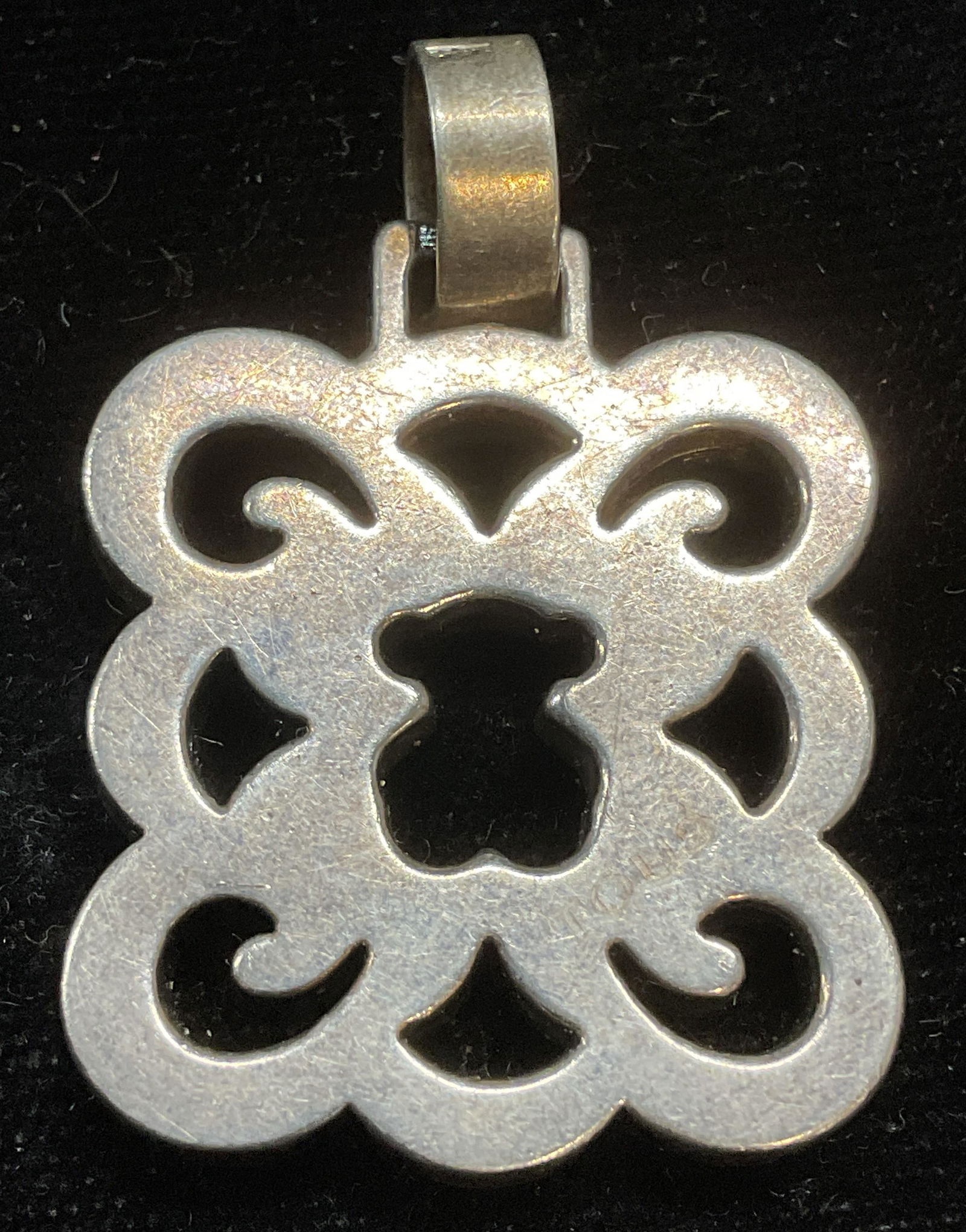 Tous Sterling Silver Quatrefoil Bear Pendant: Signed Tois sterling silver quatrefoil shaped cut out pendant with bear motif. Measures approx 1 x 1 inches. Total weight 8.3 grams. Tests for sterling using acid test. Some scratching. Jewelry, estat