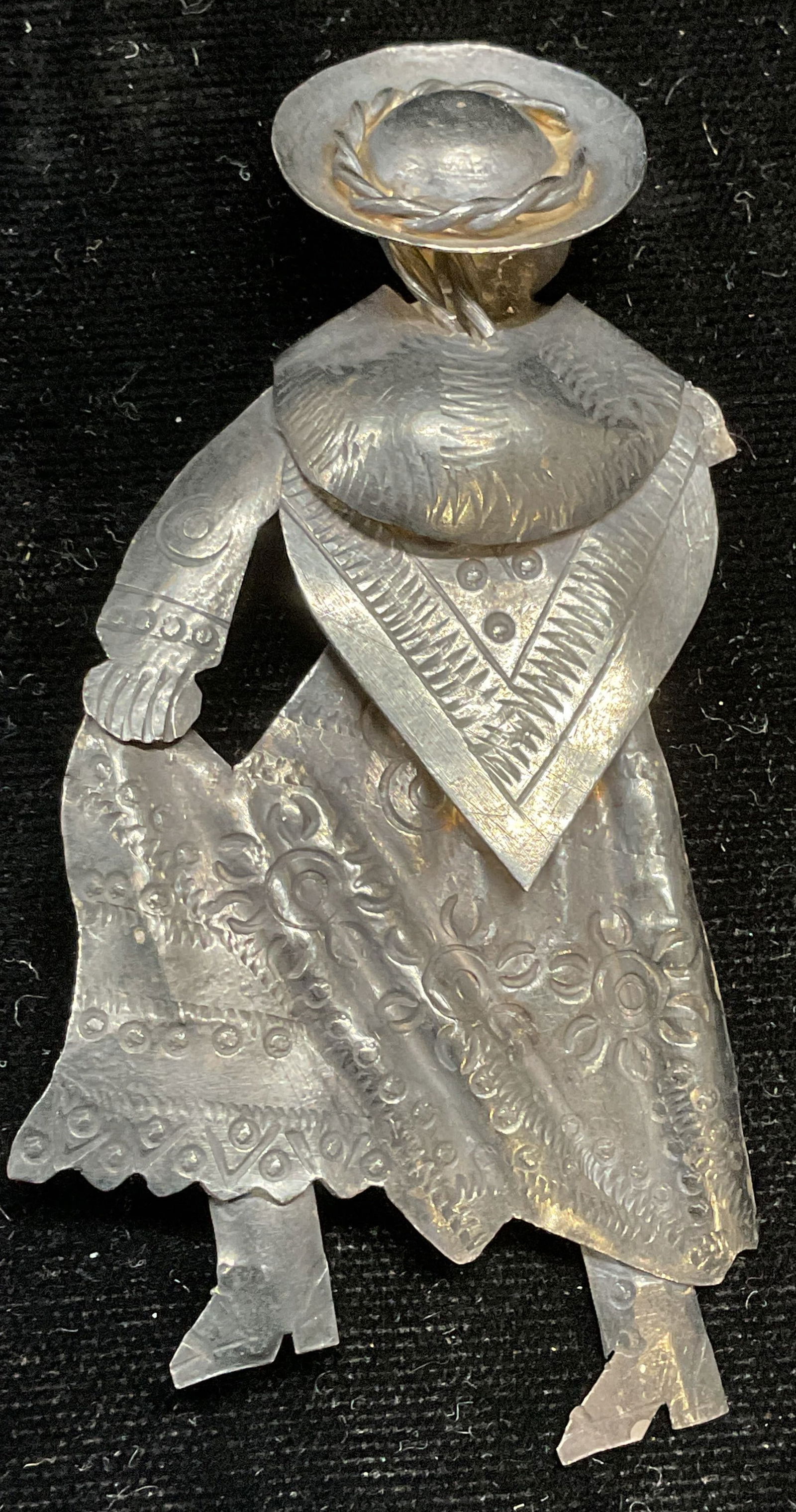 Signed Sterling Silver Figural Woman Brooch: Vintage signed sterling silver brooch. Figure of woman wearing dress and hat. Repousse raised design. Signed illegibly. Marked sterling. Measures approx 3.25 x 1.5 inches. Total weight 12.6 grams. Som