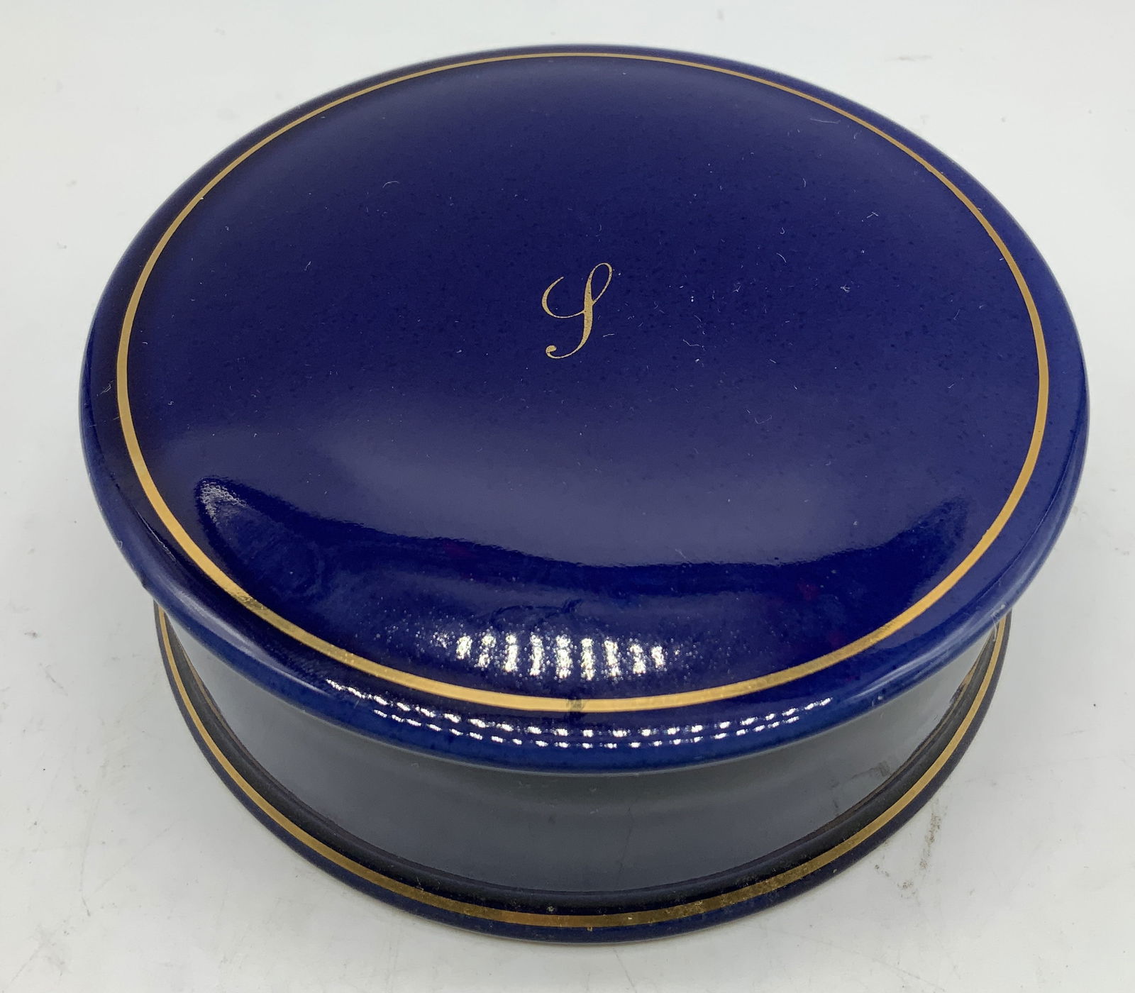 Holkham Cobalt Blue & Gilt Ceramic Box ENG: Holkham ceramic trinket box features a cobalt blue & gilt finish. Lid of box has a letter monogram. Signed & marked on underside. Reads, HOLKHAM ENGLAND. Surface wear consistent to age, use & exposure