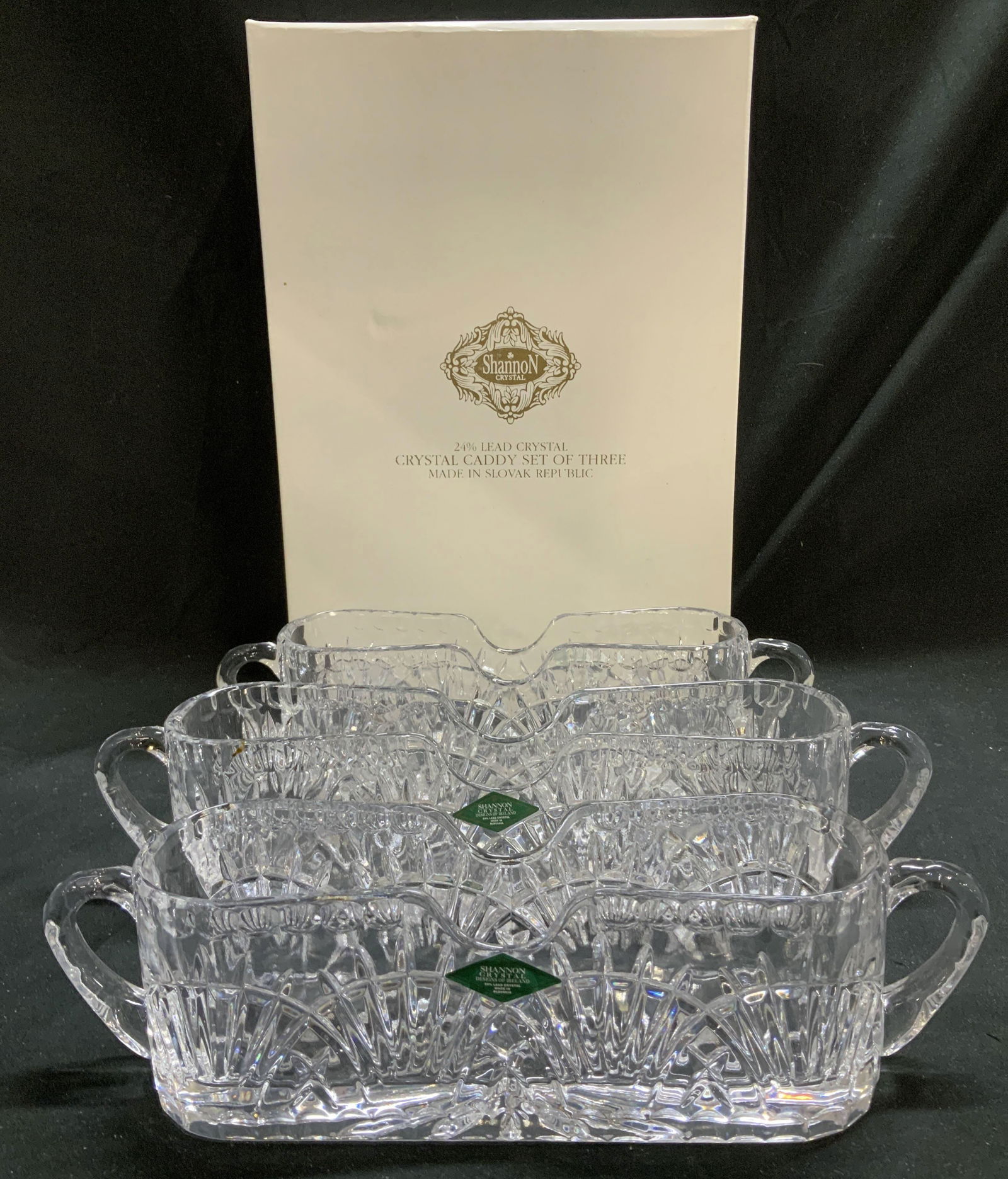 Set 3 Shannon Crystal Caddy W Bx SLOVAK Rpblc: Lot includes, crystal caddy set of 3. 24% lead crystal. Caddys feature double handles & cut pattern. Comes with original box. Lot is sold as is. Signed & marked. Reads, SHANNON CRYSTAL. MADE IN SLOVAK