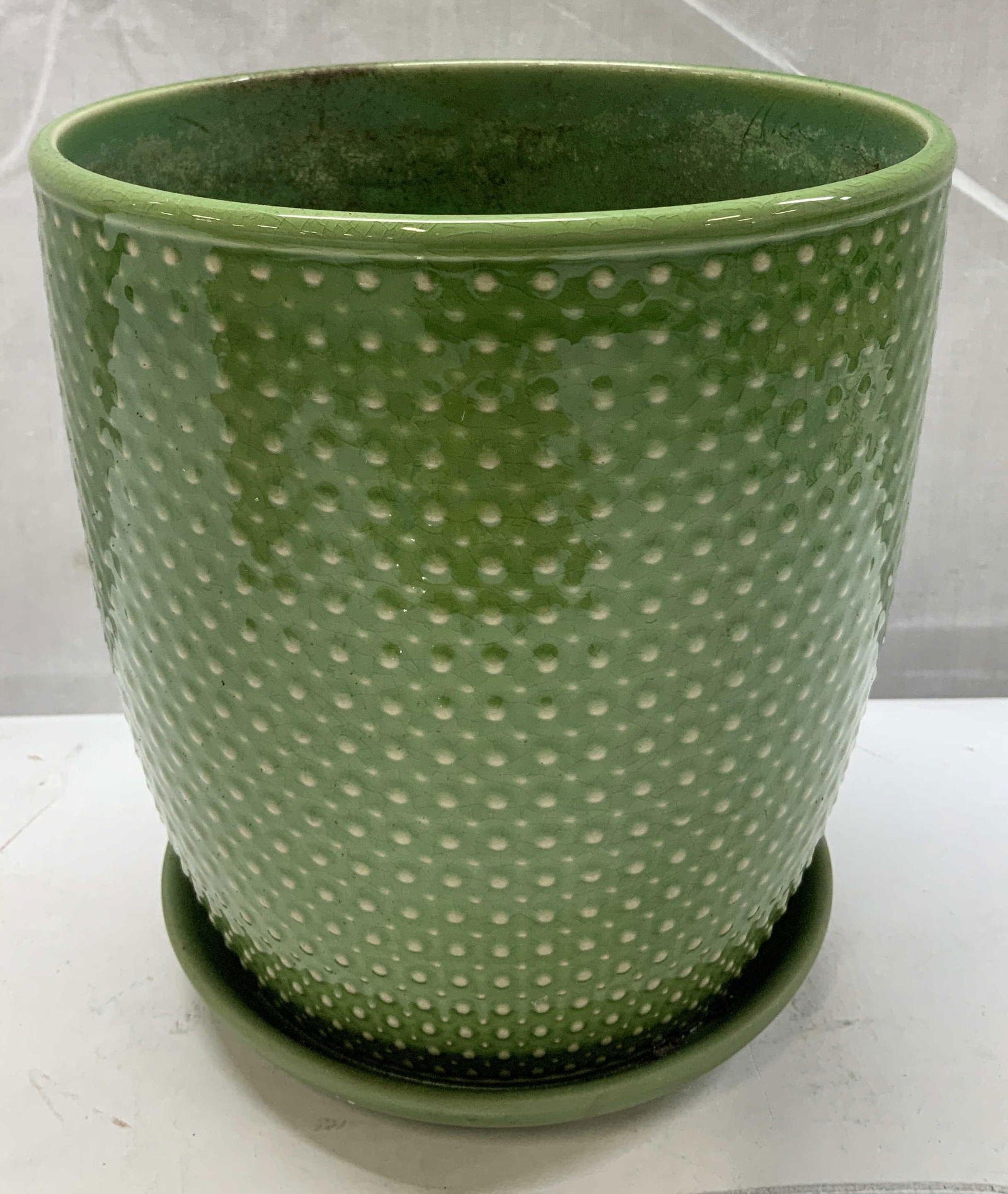Vtg Green Dot Glazed Ceramic Planter W Saucer: Vintage green glazed ceramic planter featuring a white dot pattern on body. Attached saucer. Glossy finish. Surface wear consistent to age, use & exposure. Measurements: length 7in x width 7in x heigh