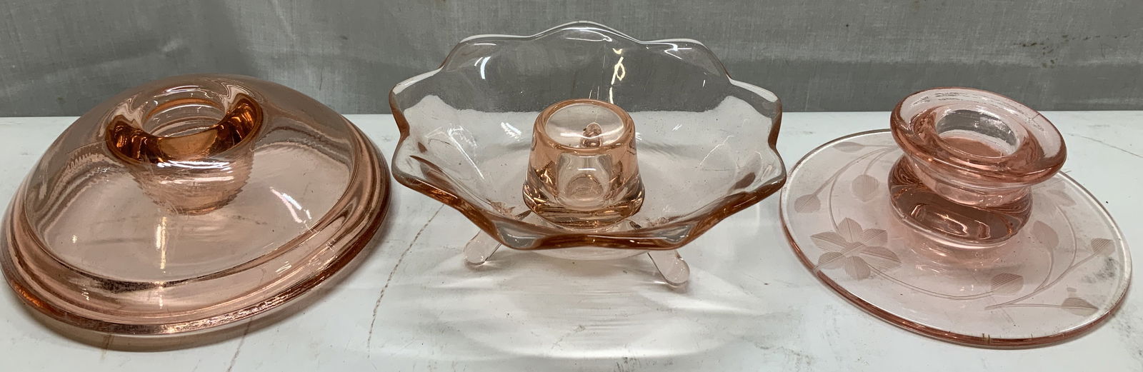 Lot 3 Vtg Pink Depression Glass Candle Holders: Lot includes, 3 assorted vintage pink depression glass candle holders featuring a floral etched design, a scalloped foot style & round shape. Lot is sold as is. Surface wear consistent to age, use & e