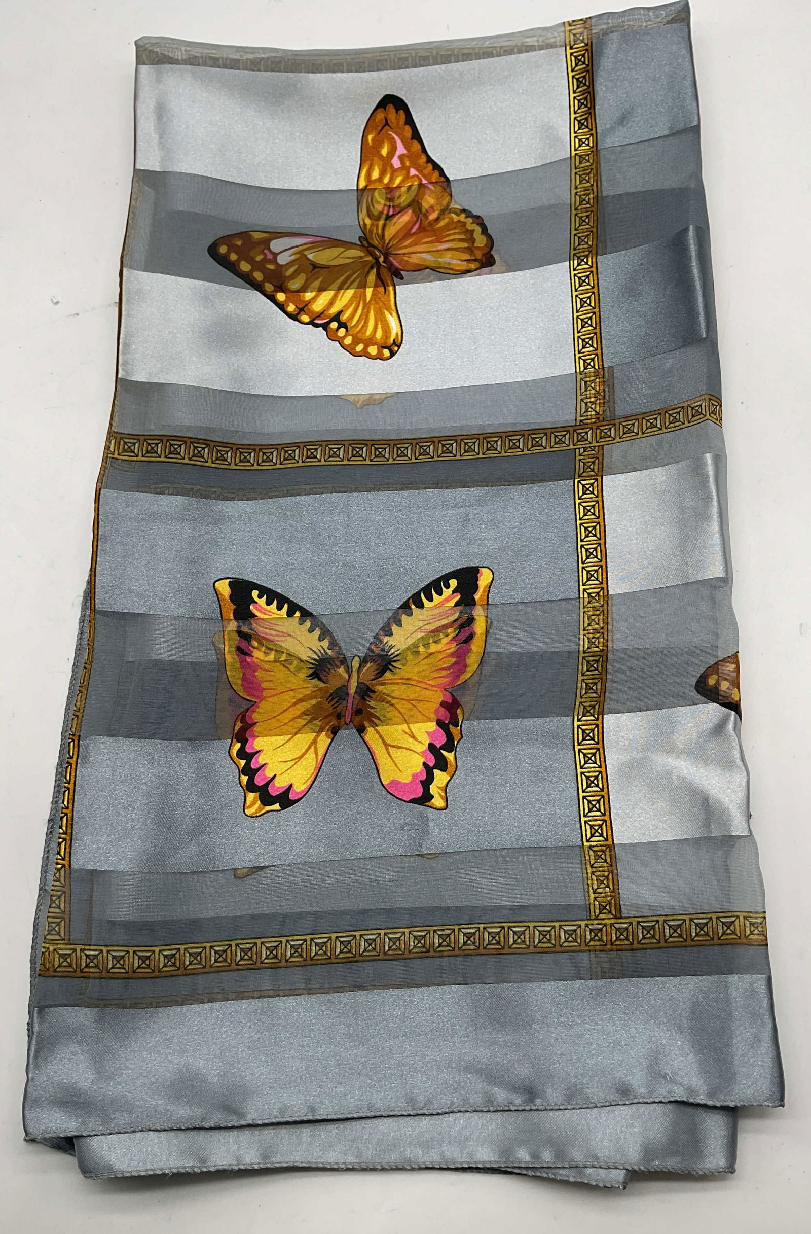 Vintage Grey Butterfly Silk Scarf: Vintage grey butterfly silk scarf. Silk material. Sheer accents. Grey stripes with gold toned geometric border. Butterfly pattern in yellow, pink, and black. Measures approx 38 x 38 inches. Wear consi
