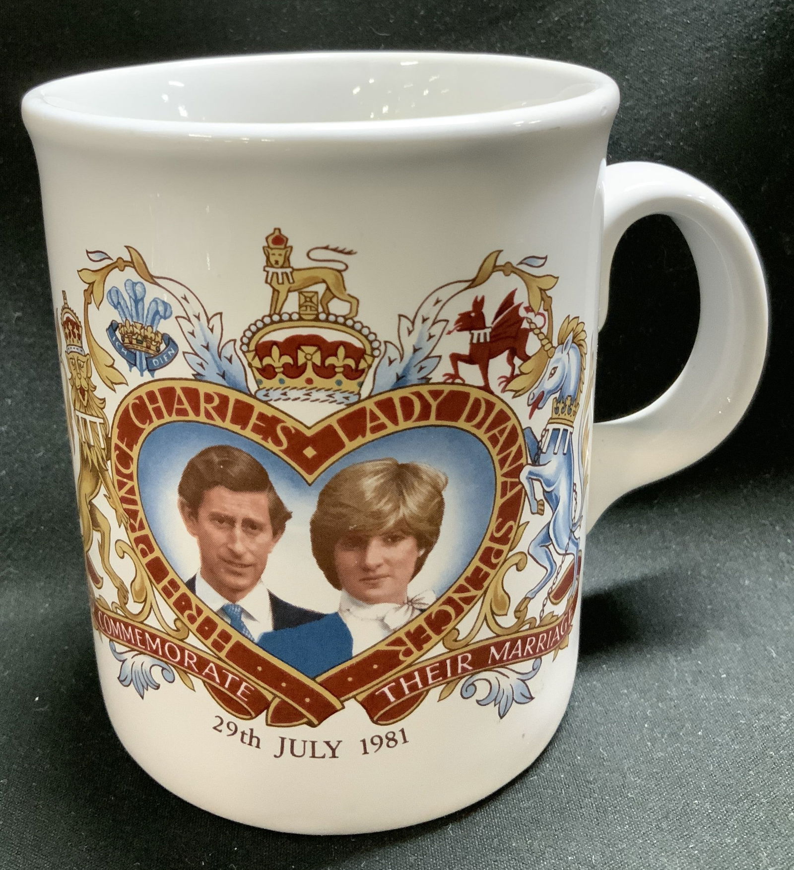 Vtg Charles & Diana Commemorative Mug 1981: Commemorative mug celebrating the royal wedding of Prince Charles and Lady Diana Spencer on July 29, 1981. It features portraits & royal coat of arms design. Property of opera singers estate from the