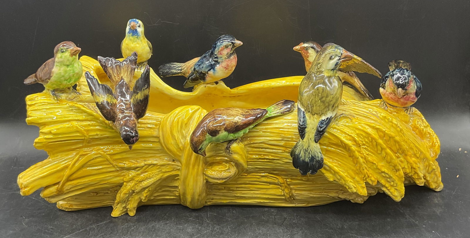 Antique Majolica Ceramic Bird & Wheat Jardiniere: Antique majolica ceramic jardiniere planter. Birds perched on wheat bales. Hand painted. Measures approx 16 x 8 x 7.25 inches. One bird previously repaired. One wing chipped. Wear including hairline a