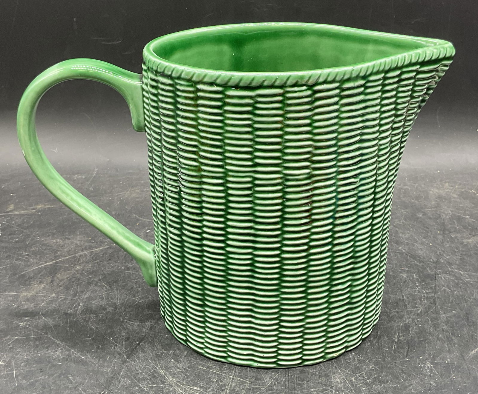 Este Green Ceramic Basket Weave Pitcher Italy: Vintage signed Este green ceramic basket weave pattern pitcher. Made in Italy. Measures approx 9.5 x 5.25 x 6.25 inches. Neiman Marcus label on underside. Some crazing and small chips. Este pitcher, c