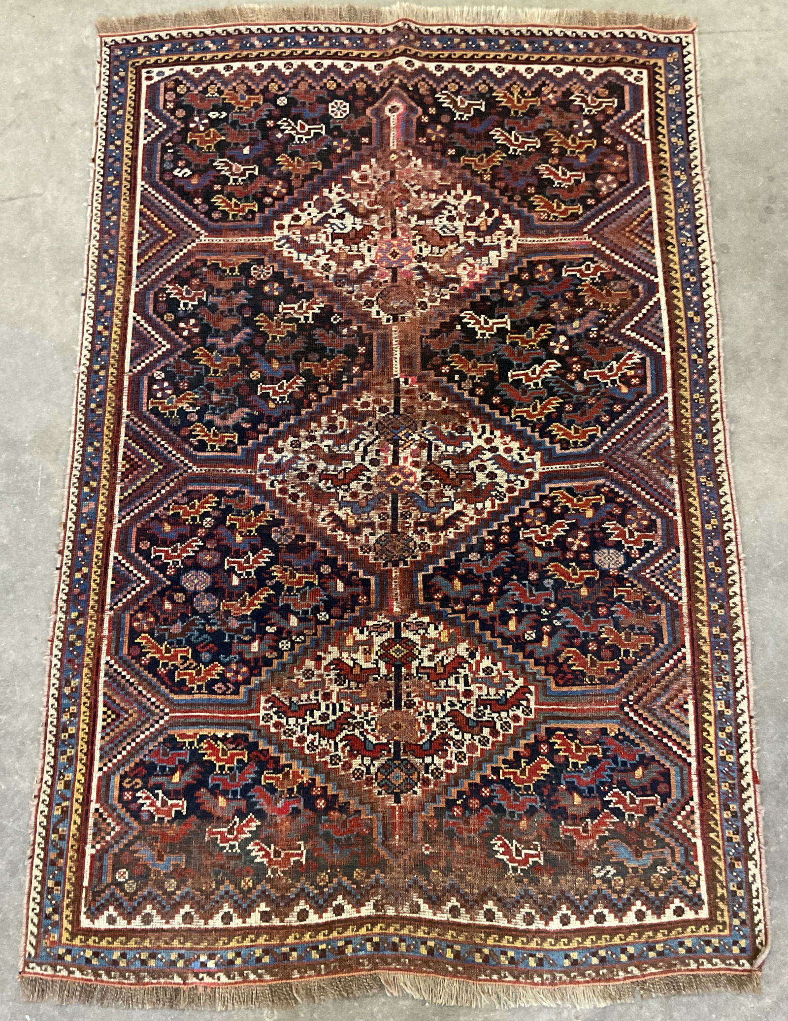 Antique Persian Qashqai Style Wool Rug: Antique Persian Qashqai style wool area rug. Geometric medallion pattern in red and purple. Measures approx 60 x 40 inches. Wear including discoloration and losses. Rug, area rug, antique rug, wool ru