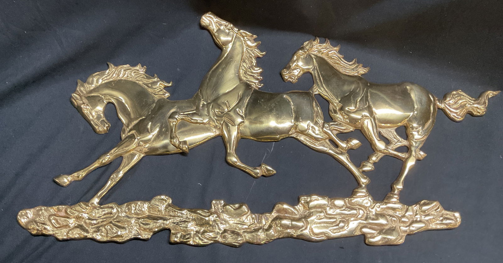 Vintage Brass Galloping Horses Wall Plaque: Vintage brass wall hanging plaque. Three galloping horses. Measures approx 26 x 13 inches. Some scratching. Horse plaque, horse wall hanging, brass horse, wall plaque, wall decor, wall accessories, ho