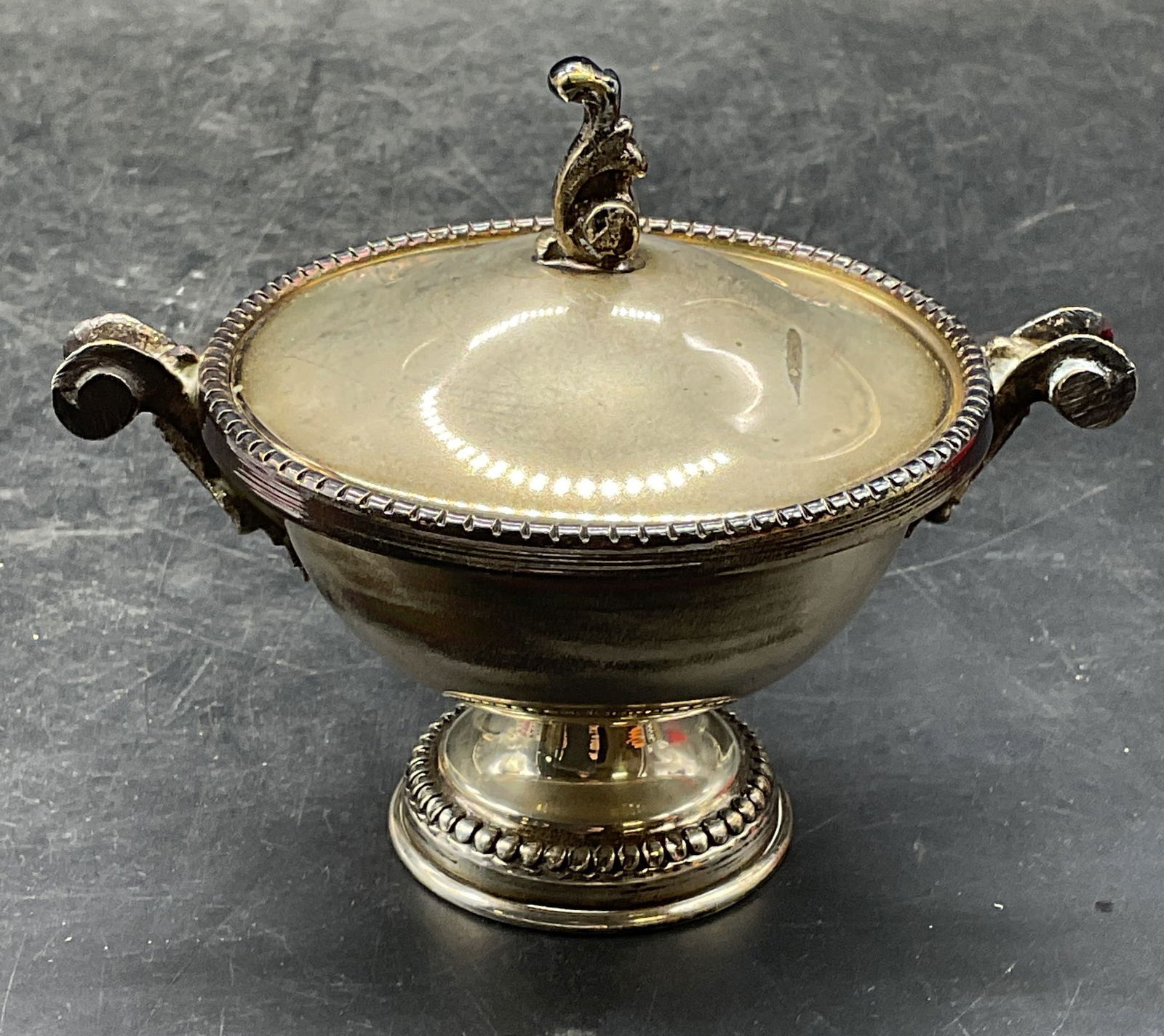Vintage 800 Silver Footed Sugar Bowl: Vintage 800 silver lidded sugar bowl. Ornate scroll handles and bead border. Marked 800, additional mark illegible. Measures approx 4.5 x 3 x 3.5 inches. Total weight 116.5 grams. Wear including patin