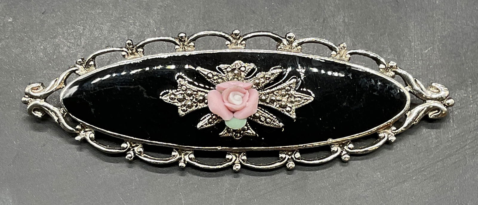 Silver Tone Black Enamel Flower Brooch: Silver tone black enamel brooch with pink flower. Measures approx 3 x 1 inches. Some scratching. Jewelry, estate jewelry, costume jewelry, cocktail jewelry, fashion jewelry, accessories, fashion acces