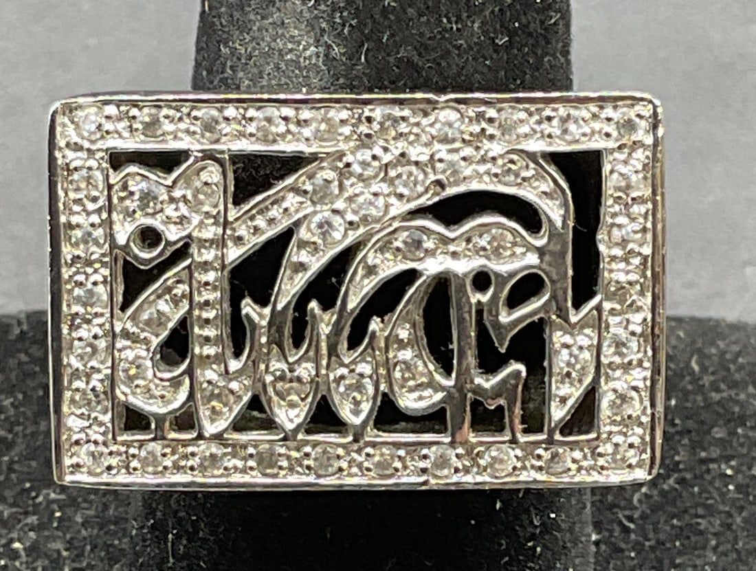 Sterling Silver Crystal Calligraphy Ring: Sterling silver ring with calligraphy design and colorless crystals. Ring size 8. Marked sterling. Total weight 12.9 grams. Some scratching. Jewelry, estate jewelry, fine jewelry, cocktail jewelry, fa