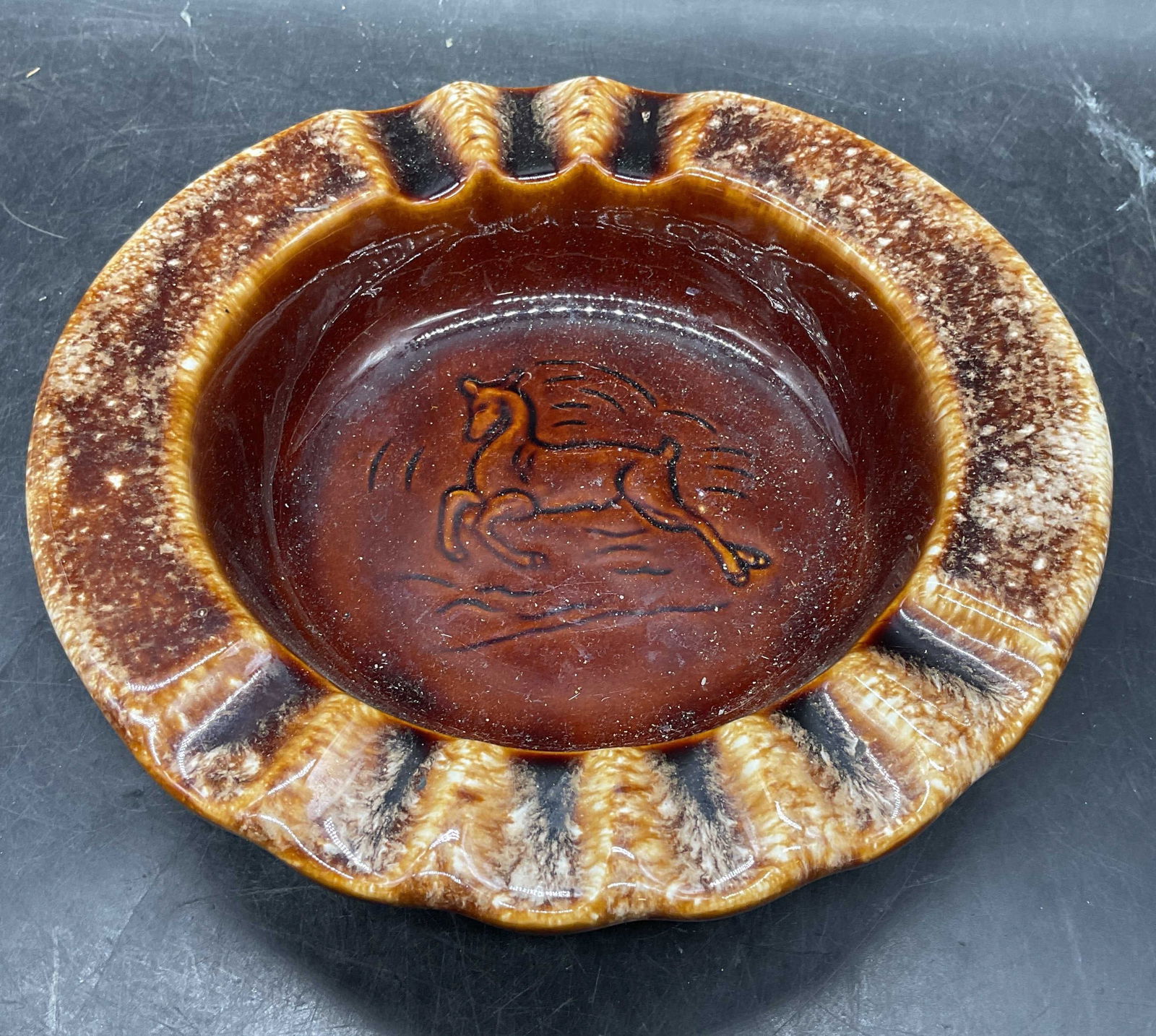 Vintage Hull Pottery Leaping Deer Ceramic Ashtray: Vintage signed Hull ceramic ashtray, leaping deer pattern. Brown drip glaze. Made in USA. Measures approx 8 x 1.75 inches. Some scratching. Hull ashtray, vintage ashtray, deer ashtray, ceramic ashtray
