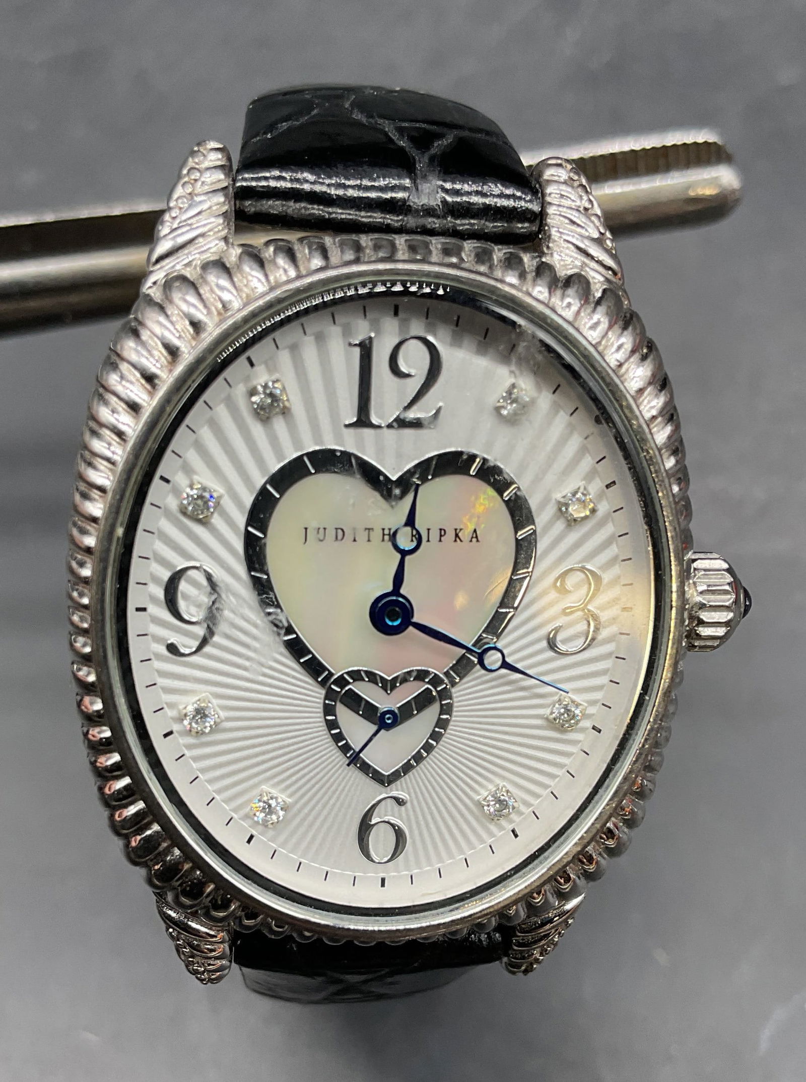 Judith Ripka Sterling Silver Leather Watch: Signed Judith Ripka sterling silver case watch with stainless steel back and clasp. Black leather strap. Marked sterling. Case measures approx 1.5 x 1.25 inches. Total weight including non sterling 41