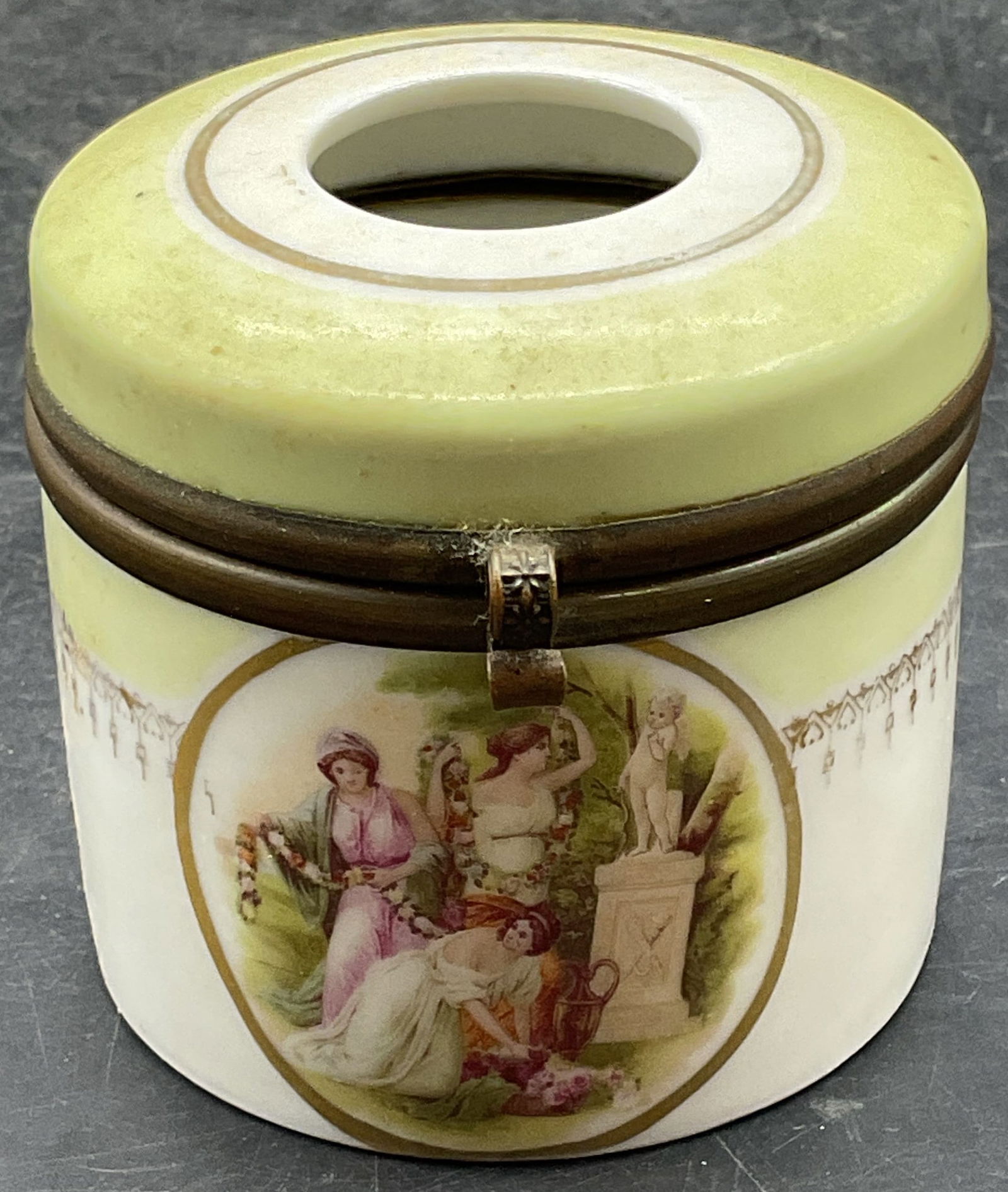 Vintage Gilt Porcelain Hair Receiver Jar: Vintage porcelain hair receiver jar. Hinged with brass frame. Hand painted gilt decoration and classical style figure group. Measures approx 2.75 x 2.5 inches. Wear including scratching and loss to pi