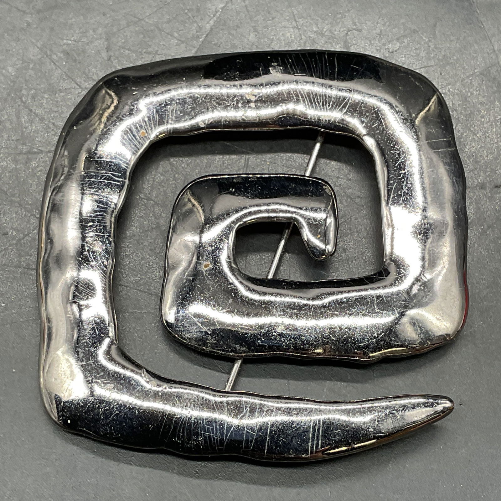 1986 JJ Silver Tone Square Swirl Brooch: 1986 signed JJ JONETTE Jewelry silver tone square swirl brooch. Measures approx. 2.25 x 2.25 inches. Some scratching. Property of Upper East Side French stage and screen actors estate, Manhattan. 