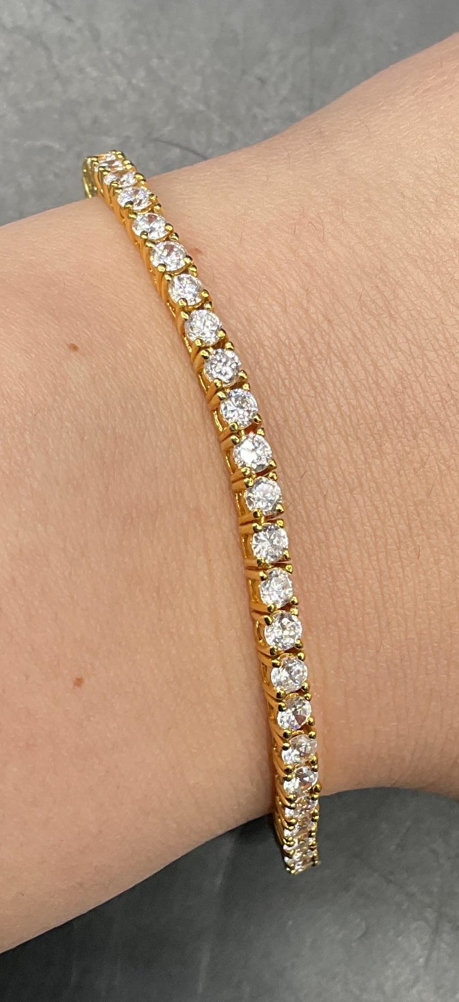 Signed Sterling Silver Gold Plated CZ Bracelet: Sterling gold plated sterling silver bracelet with cubic zirconia. Measures approx. 6.75 inches long. Marked sterling. Total weight 10.8 grams. Some scratching. Jewelry, estate jewelry, fine